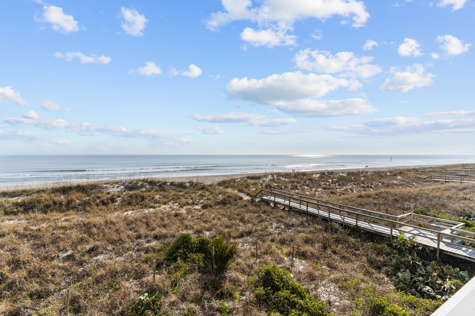 Stunning beachfront location with pristine sandy shores and scenic boardwalk access to the ocean.