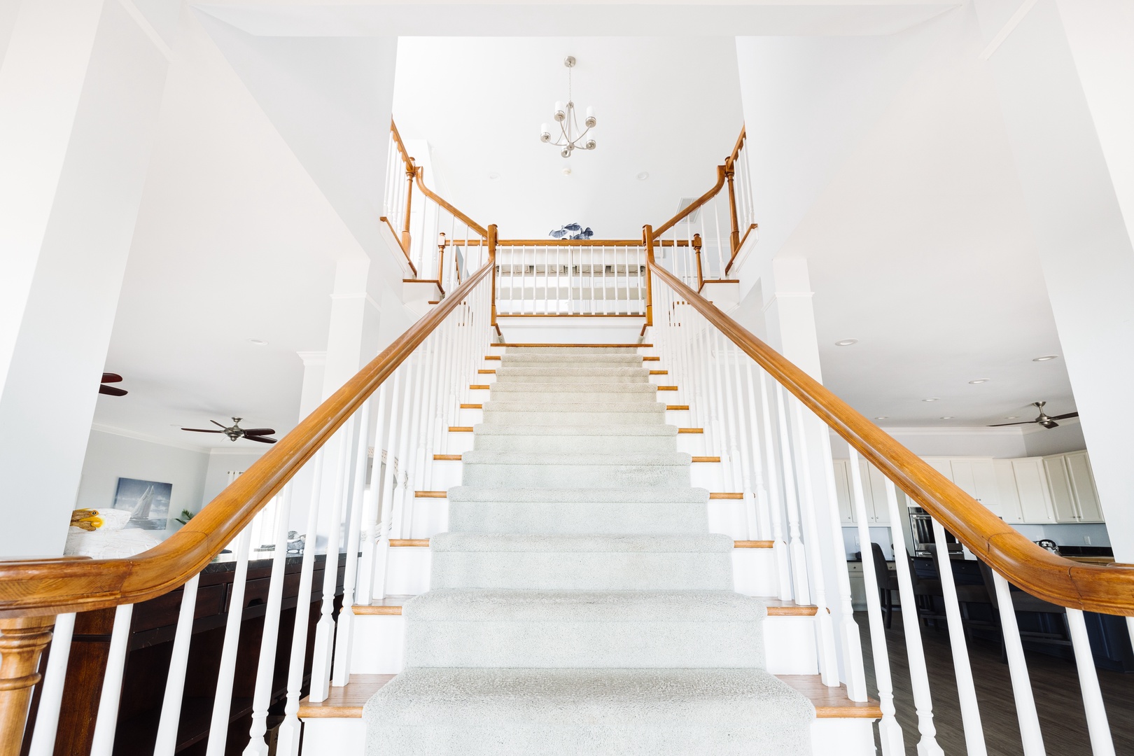 You'll love this grand curved staircase with elegant wood railings leading to your upstairs bedrooms.