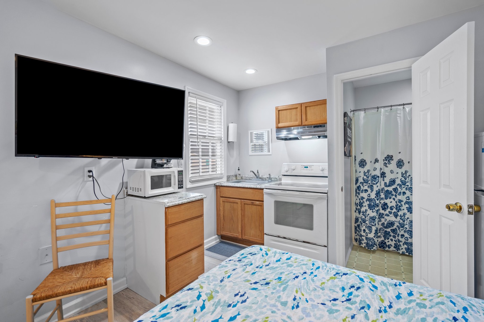 Your cozy studio features a full kitchen, large TV, and private bathroom—everything you need for a comfortable stay.