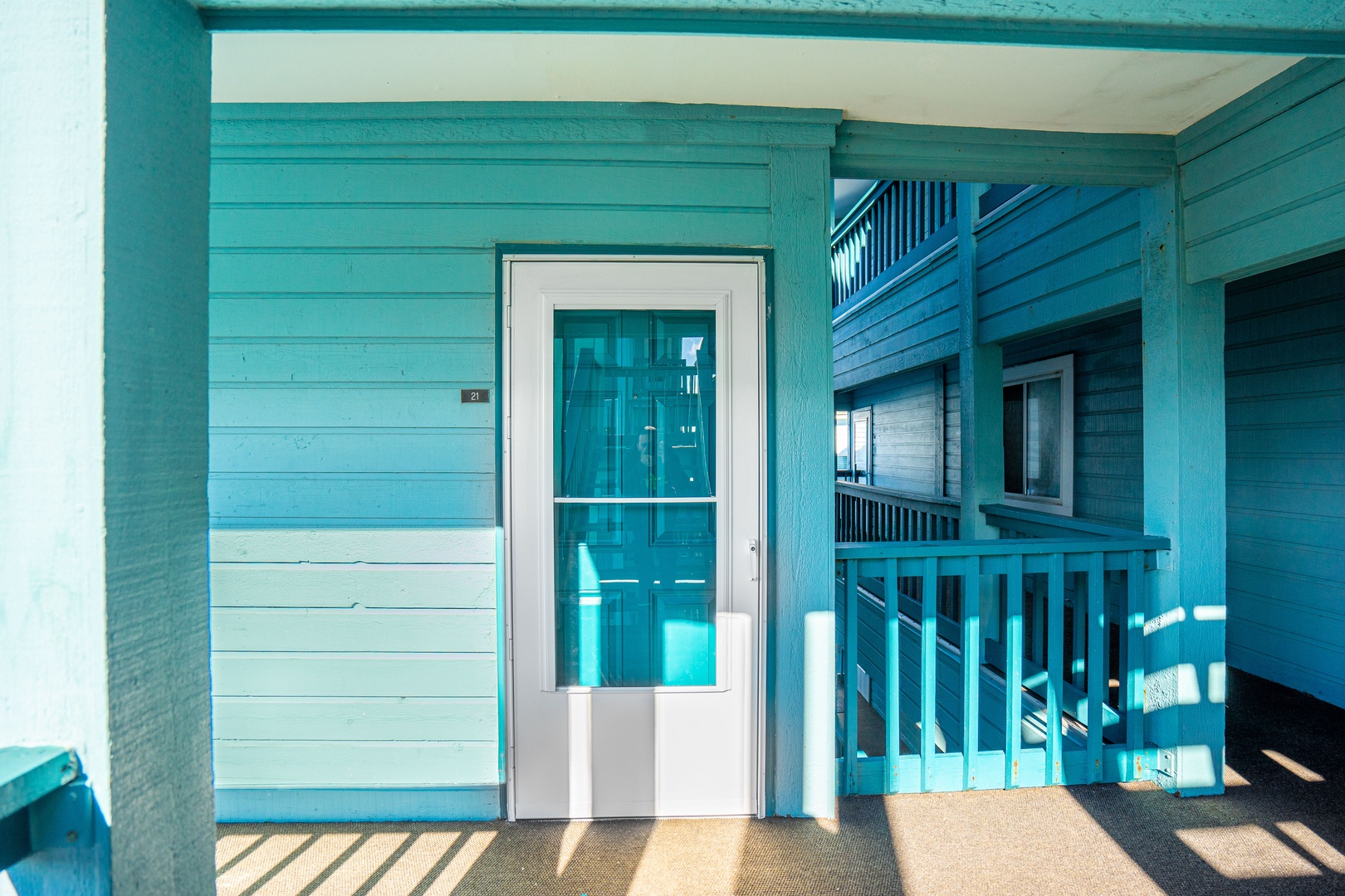 Step into your coastal retreat through this charming turquoise entrance, where beach house vibes welcome you home.