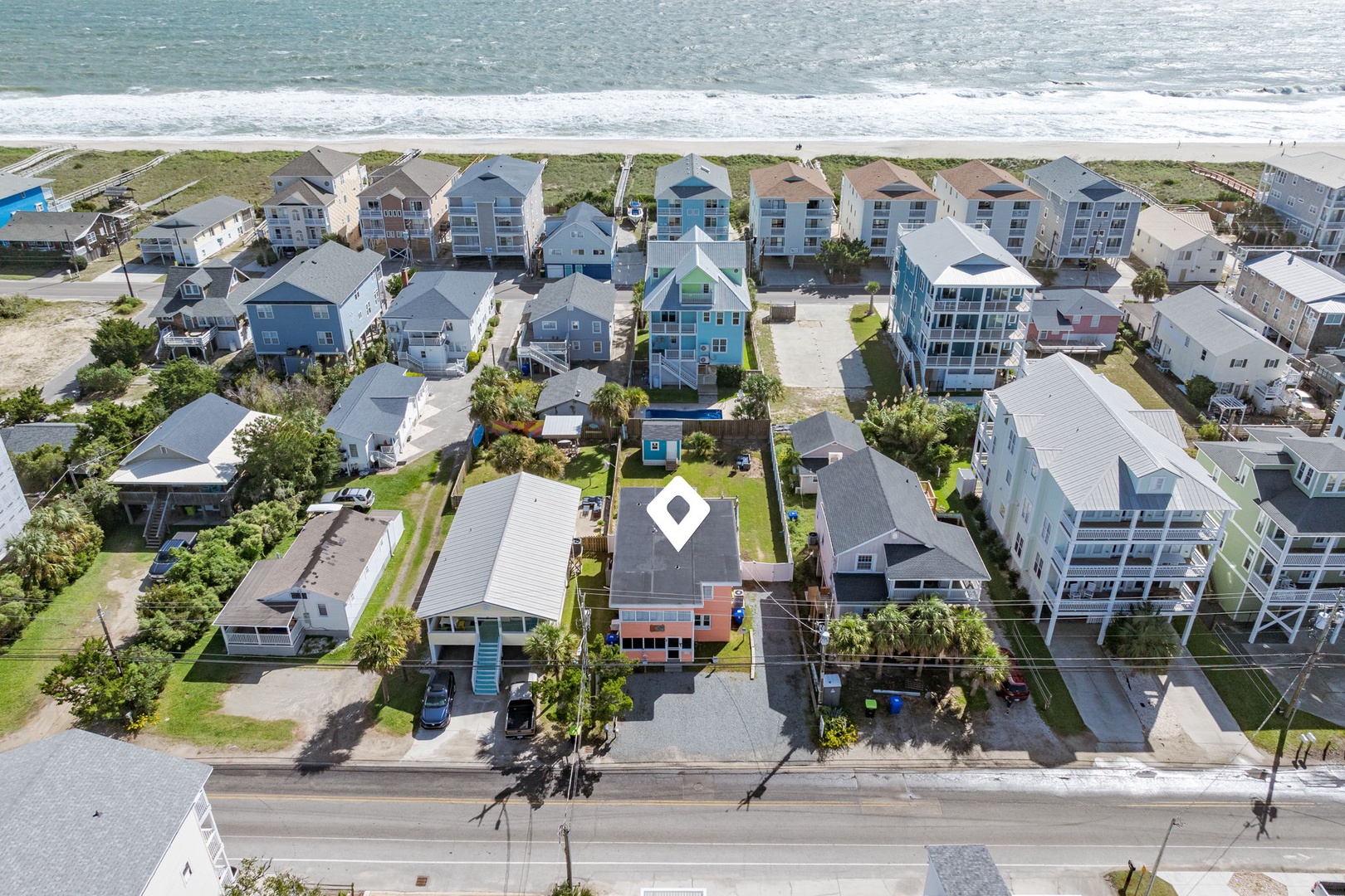 Coastal beachfront neighborhood with oceanfront access and charming beach house architecture.