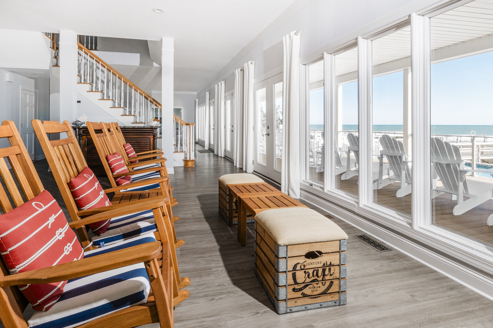 Relax in your bright coastal living room with stunning sea views and comfortable seating just steps from the beach.