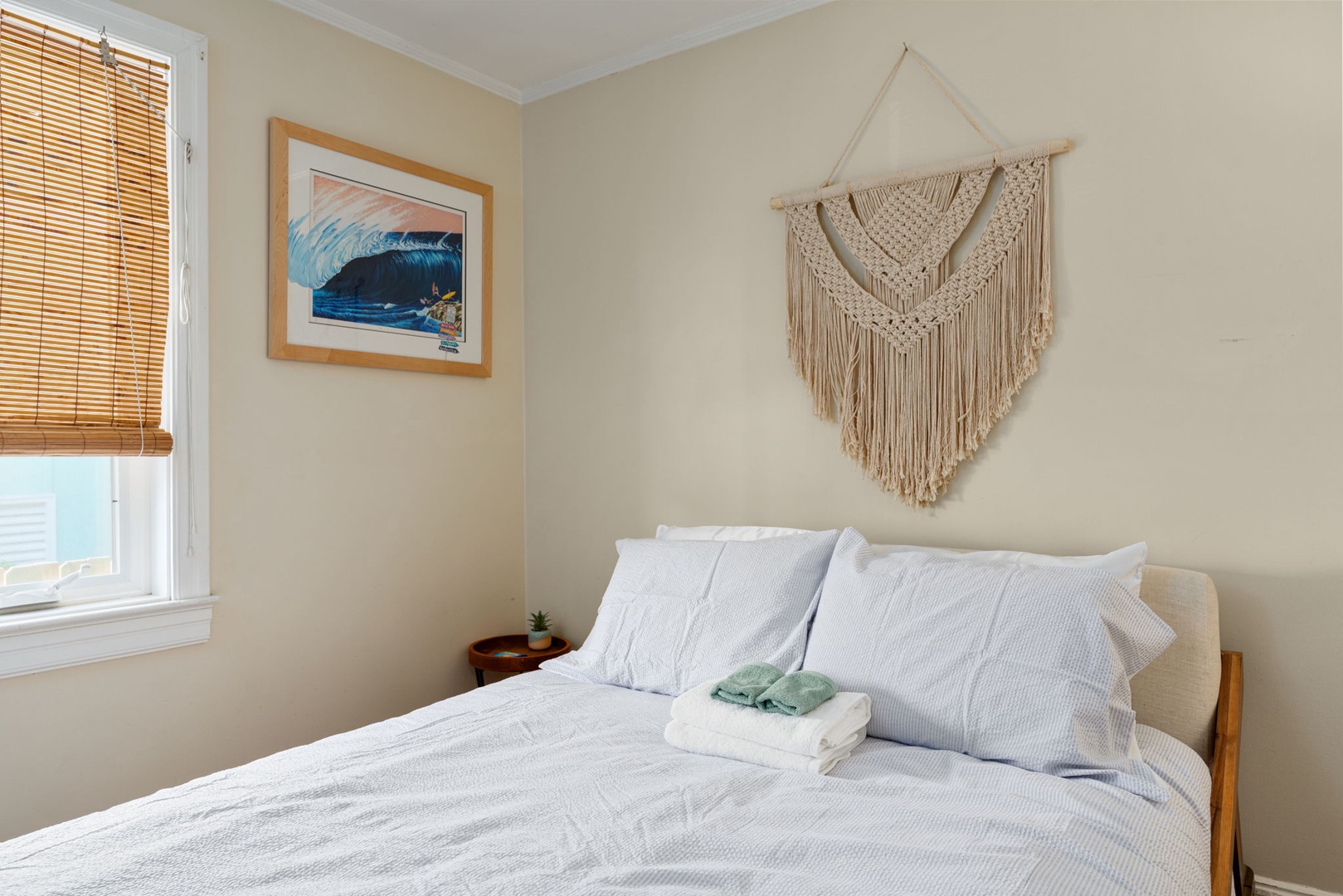 Drift off to sleep in your cozy bedroom, where coastal artwork and bohemian touches create a peaceful retreat for restful nights.
