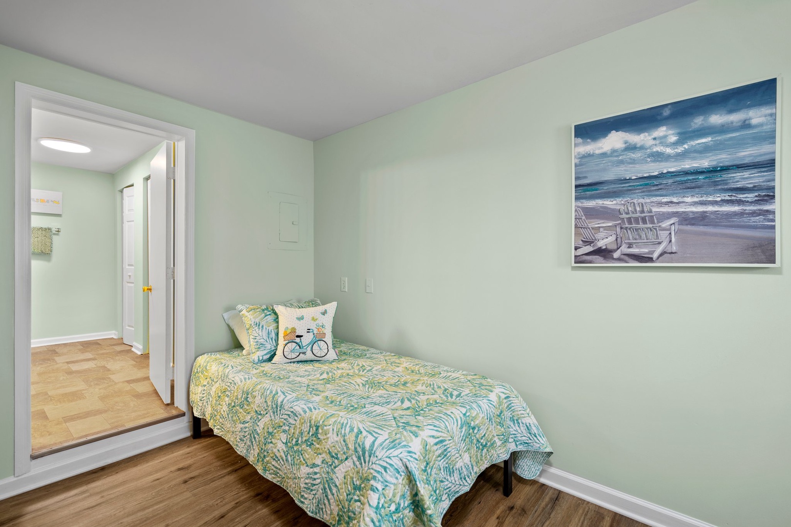 Drift off to peaceful dreams in your cozy bedroom with calming coastal colors and tropical bedding that whispers of seaside escapes.