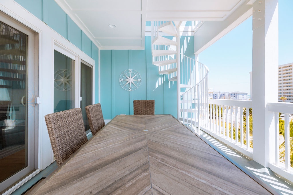 Gather around your private balcony dining table, where coastal breezes and turquoise walls create the perfect backdrop for memorable meals together.