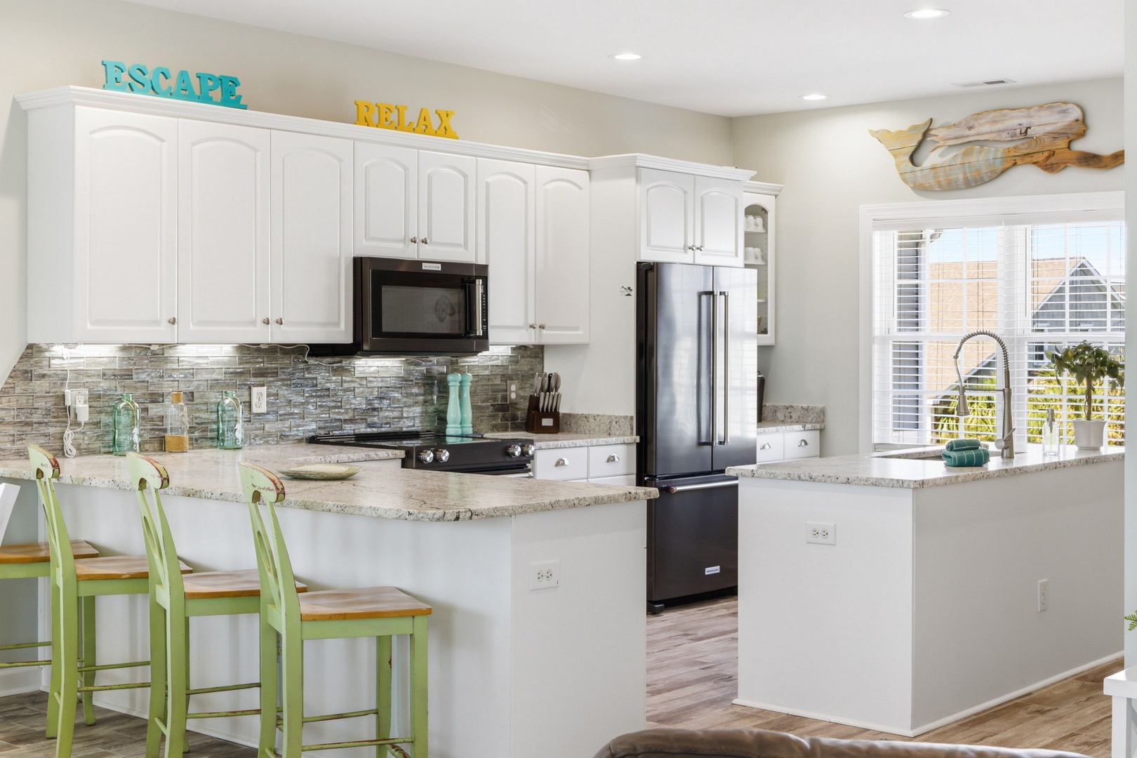 Your fully equipped kitchen welcomes you with beach-inspired touches, granite counters, and a breakfast bar—perfect for gathering, cooking, and making memories together.