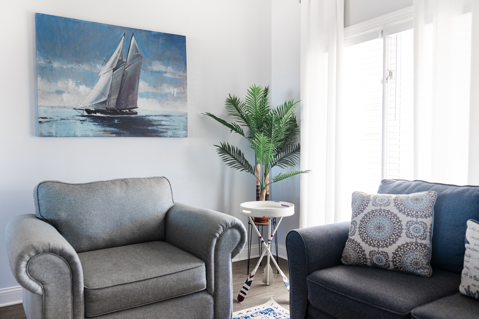 Unwind in your coastal-inspired living space with nautical charm and natural light streaming through your windows.