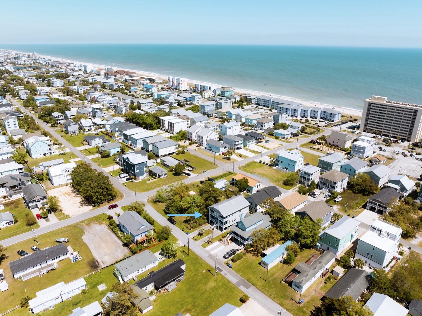 Charming beach community with pristine coastline stretching along the horizon, offering a peaceful residential setting near oceanfront amenities.