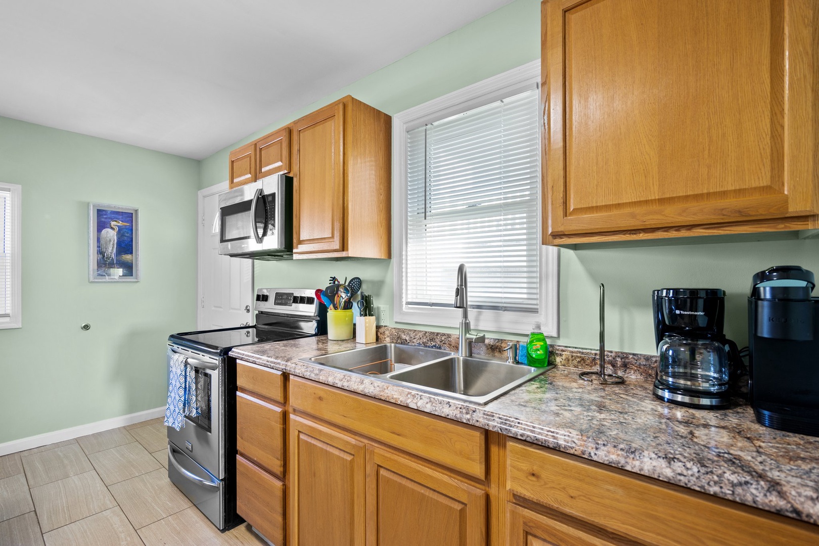 Your fully equipped kitchen awaits with warm wood cabinets, granite counters, and modern appliances to make every meal memorable.