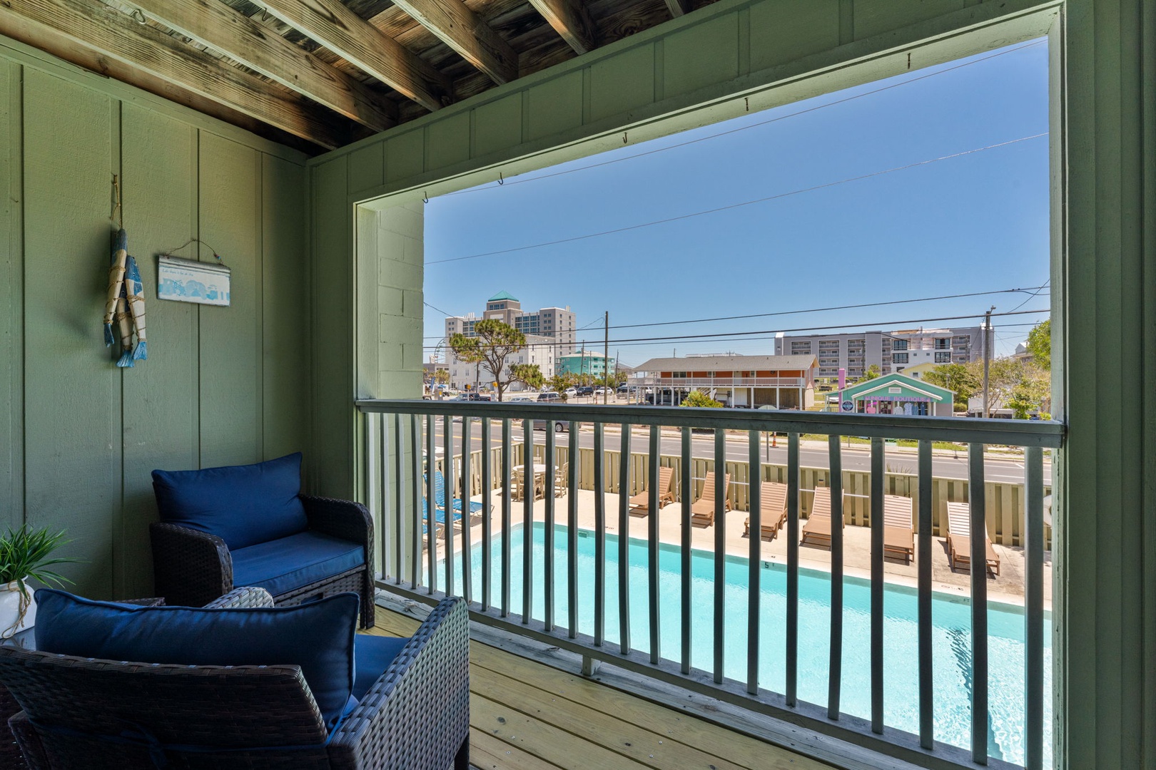 Relax in your private balcony seating with stunning pool views below and gentle coastal breezes drifting through, creating the perfect spot to unwind with morning coffee or evening conversation.