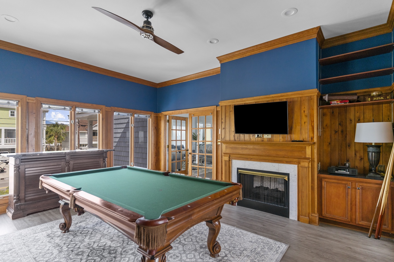 Unwind in your private game room with pool table, cozy fireplace, and built-in entertainment center - perfect for memorable evenings.
