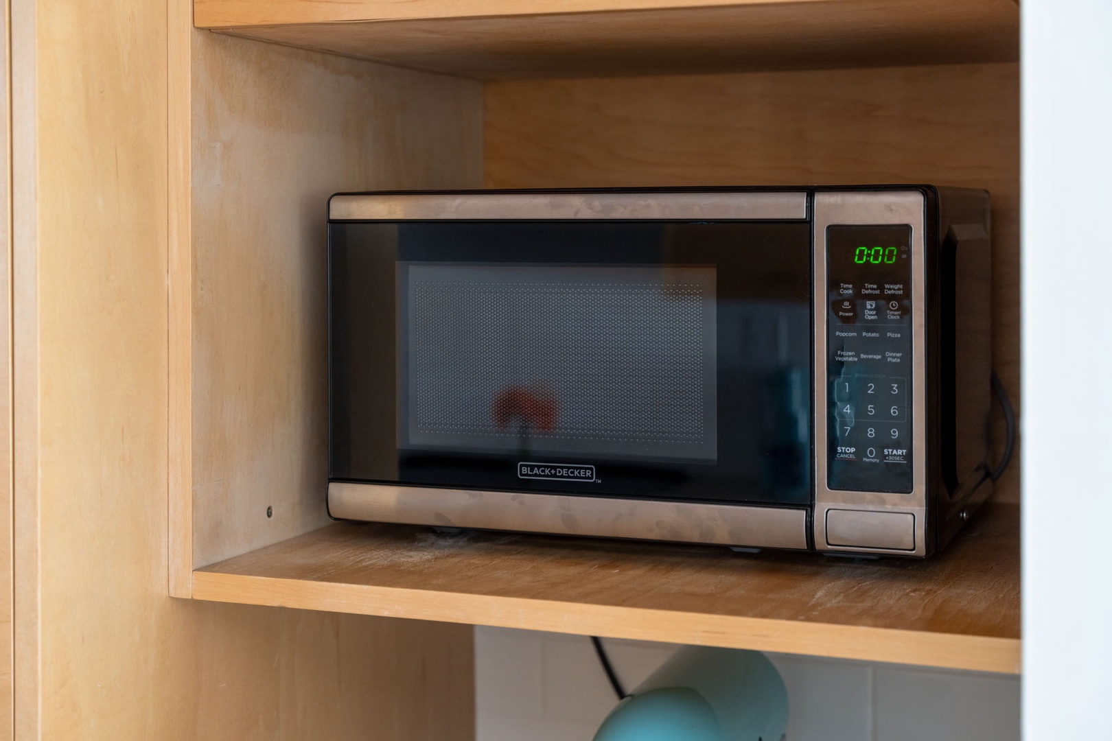 Convenient microwave ready for your quick meals and snacks, perfectly positioned in the kitchen's built-in shelving for easy access during your stay.