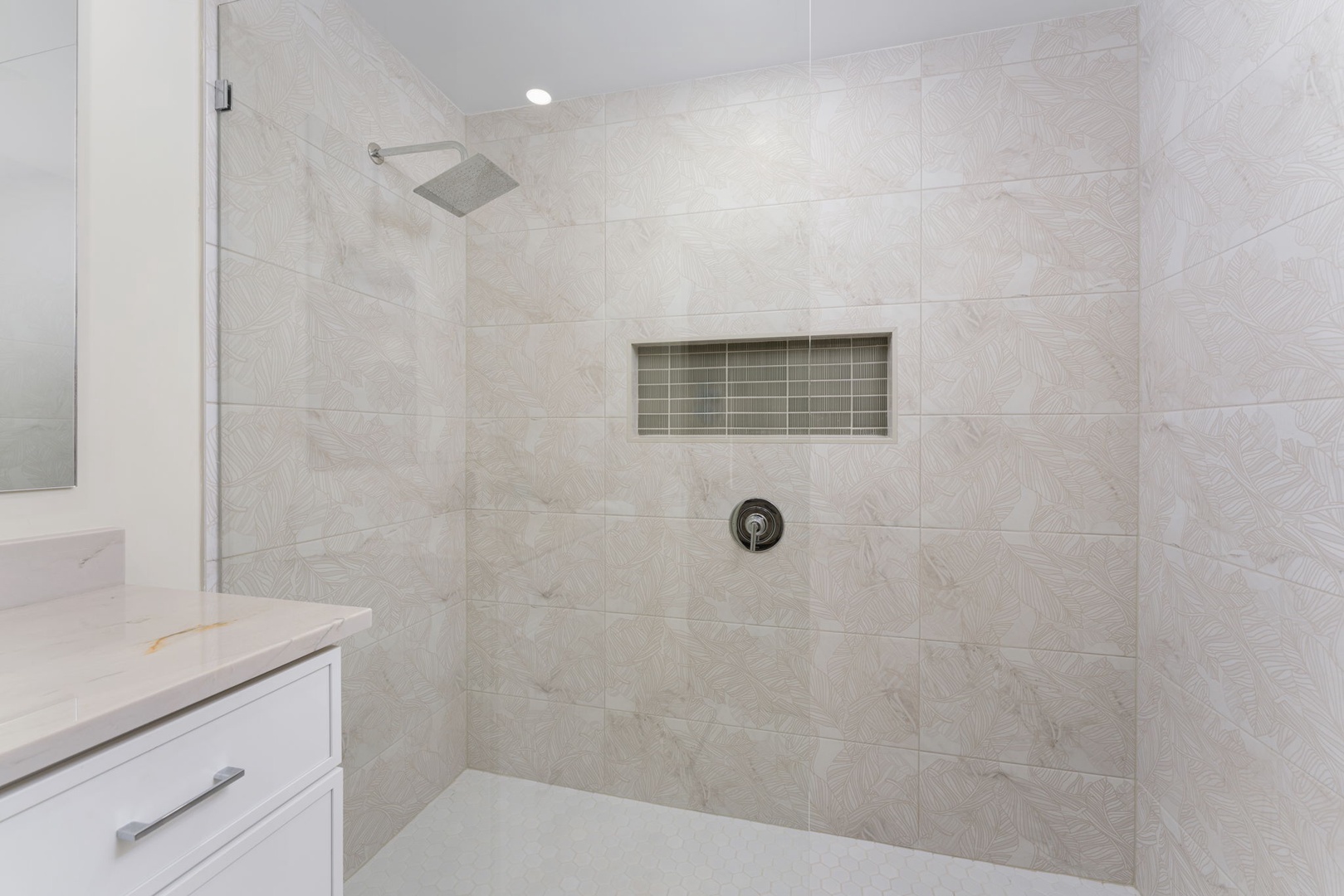 Step into your spa-like shower with elegant marble tiles and rainfall head for pure relaxation.