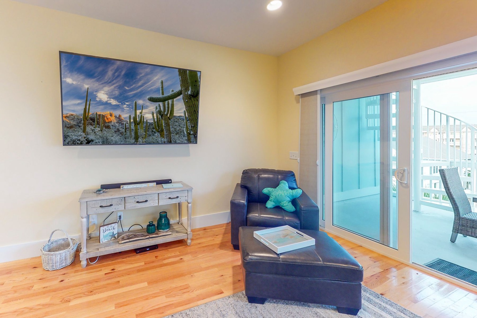 Unwind in your cozy living space with leather seating, warm hardwood floors, and private balcony access for morning coffee moments.
