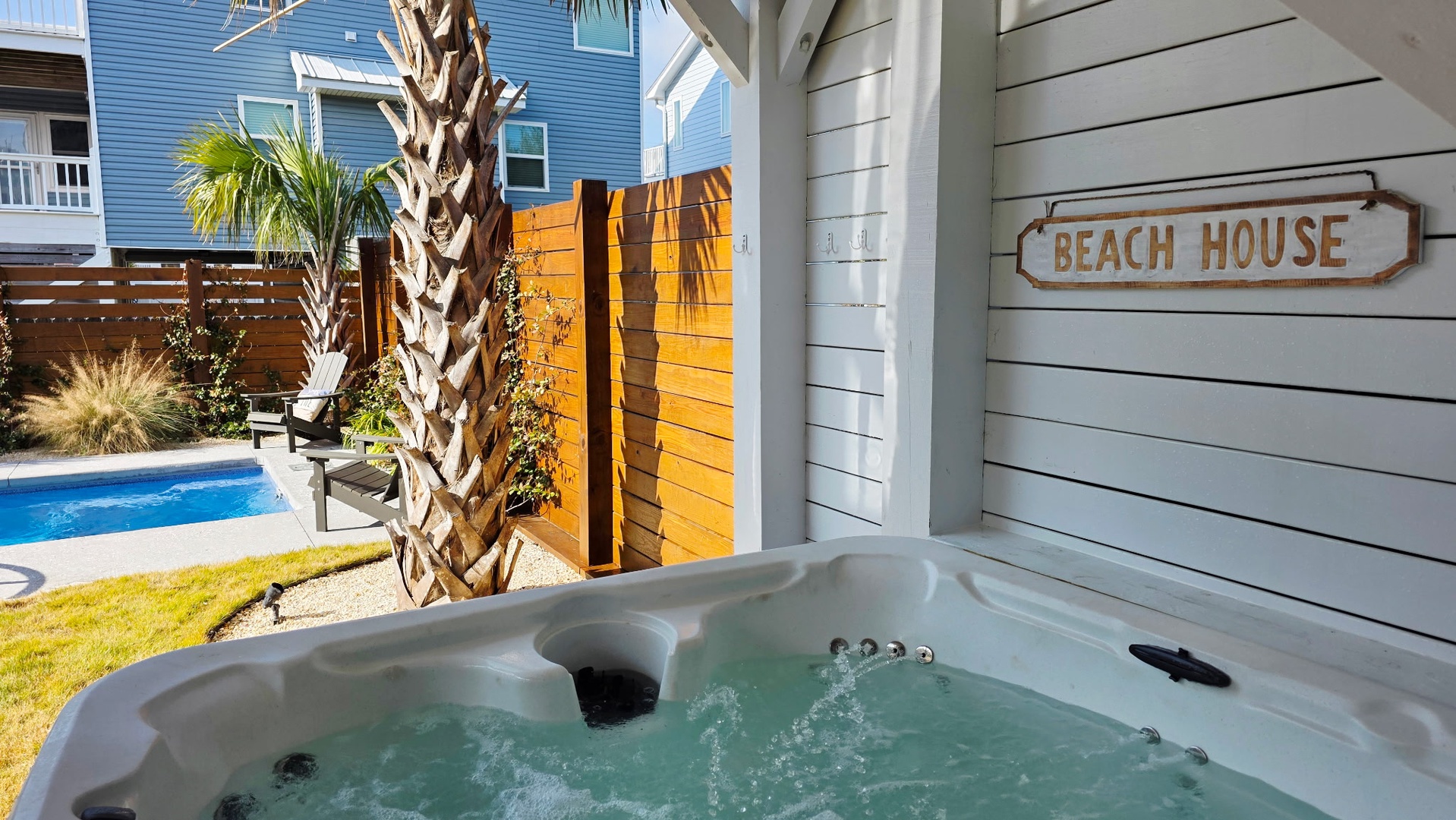 Soak in your private hot tub while gazing at the sparkling pool and swaying palms in your coastal paradise.