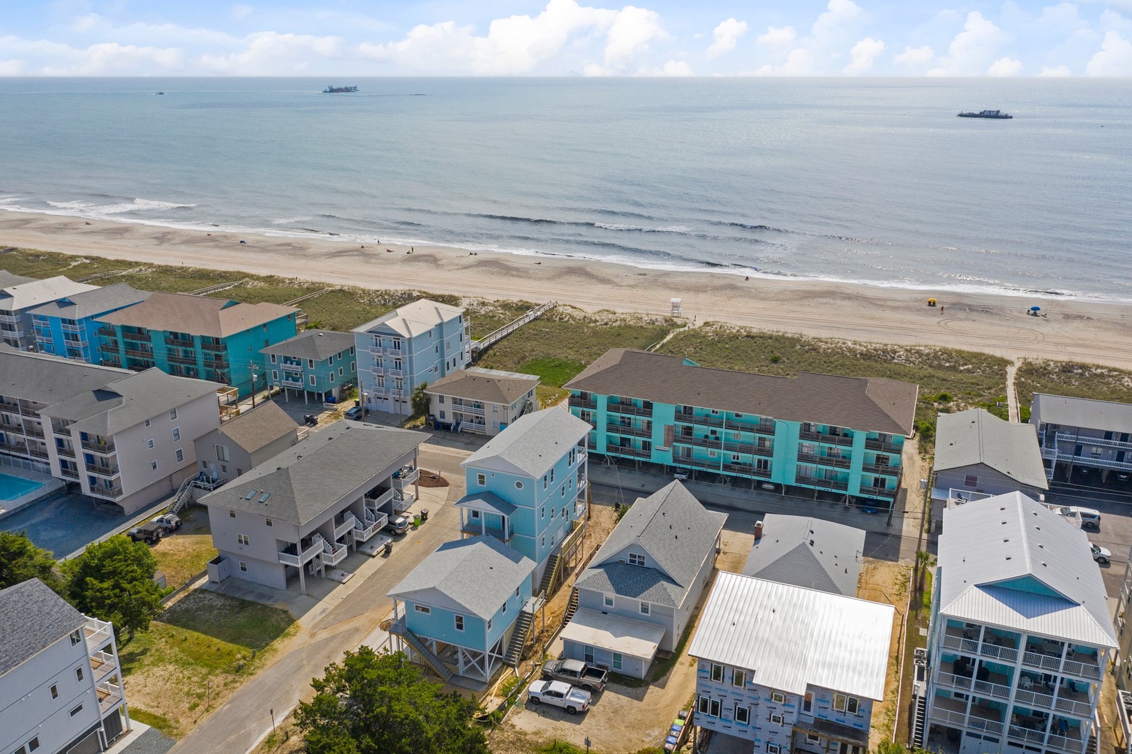 Beachfront vacation rental community offers direct beach access with expansive sandy shores and coastal views.