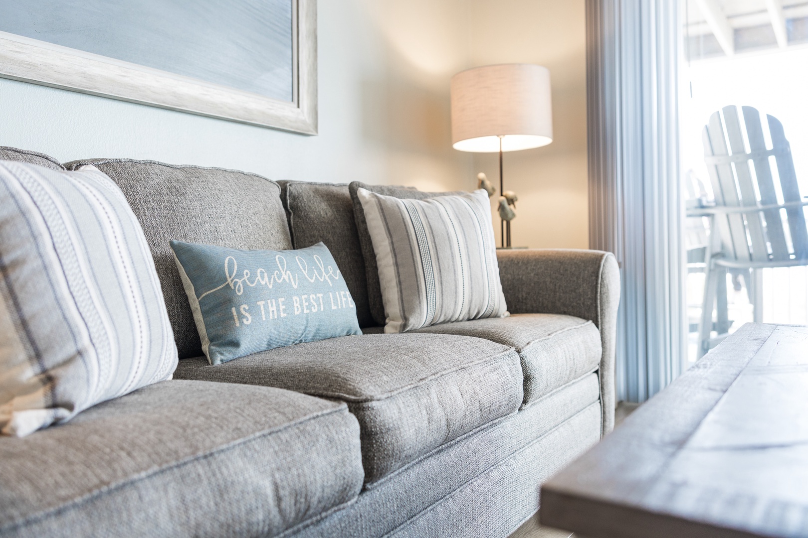 Sink into this plush sofa where soft textures and beach vibes create your perfect relaxation spot.