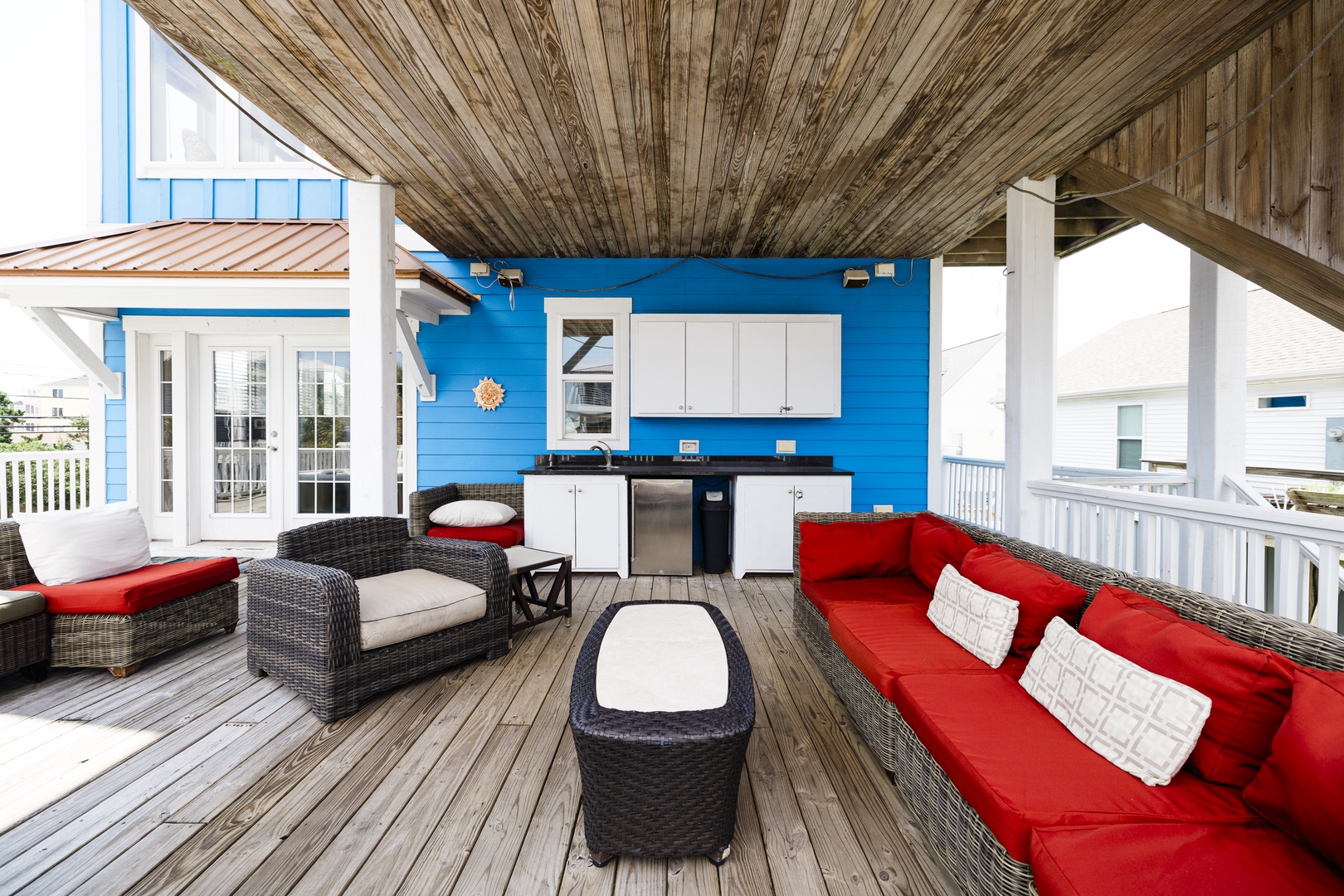 Relax on your spacious covered deck with vibrant outdoor furniture, full kitchenette, and coastal views all around.
