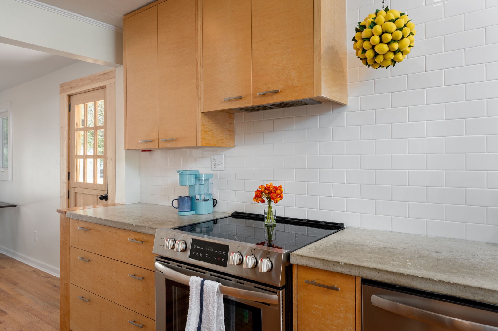 Cook memorable meals in your modern kitchen with sleek appliances, granite countertops, and cheerful natural light streaming through the window.