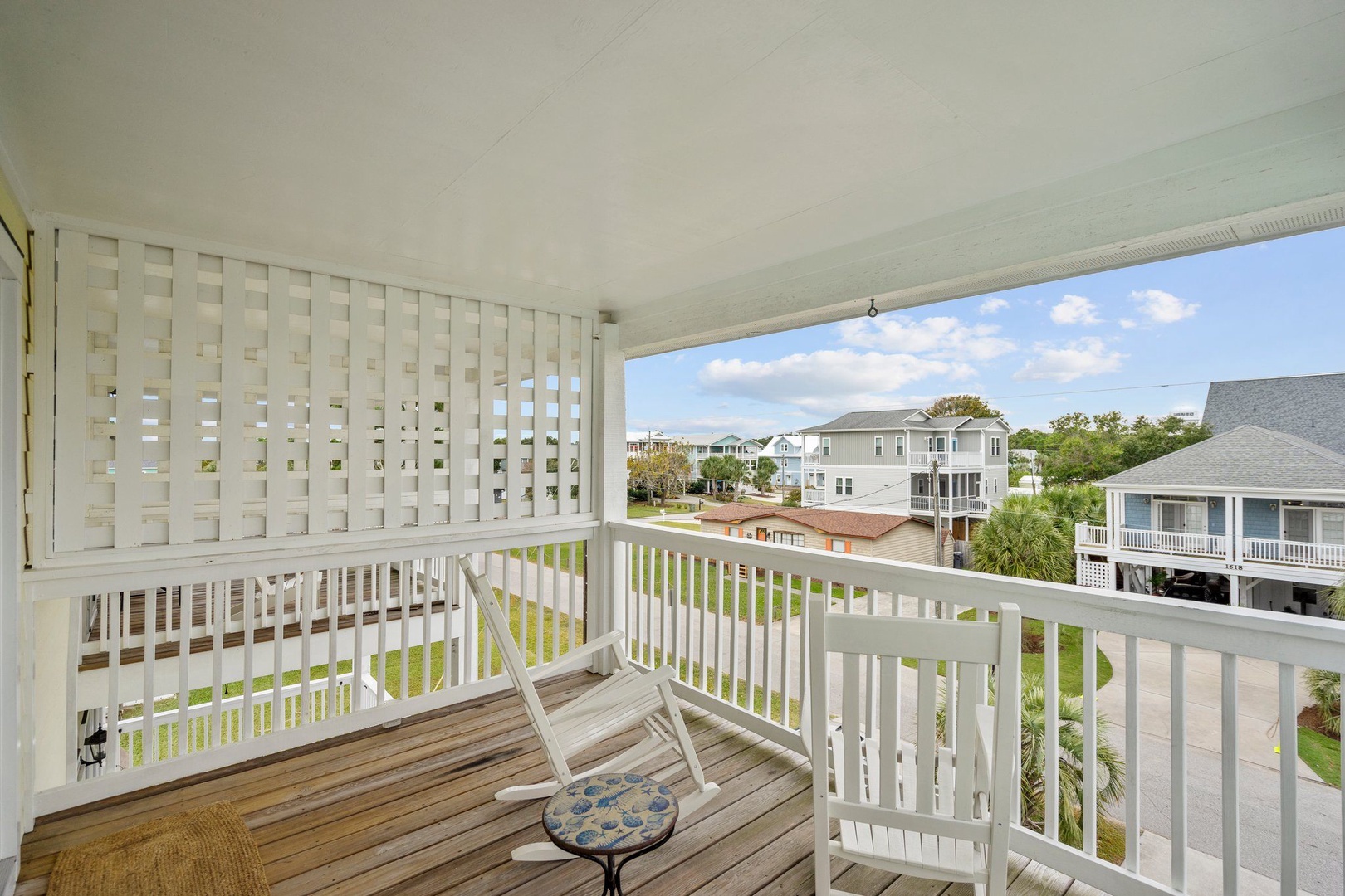 Relax on your private covered balcony with comfortable seating and peaceful neighborhood views—perfect for morning coffee or evening unwinding.