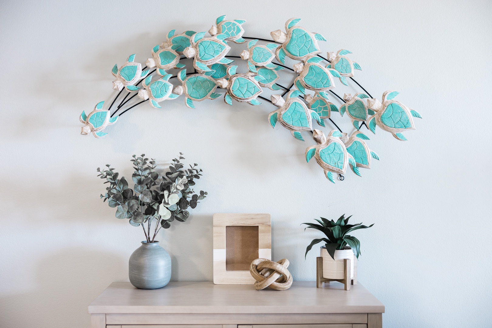 You'll love this charming coastal-themed decor featuring a stunning turquoise turtle wall art that brings ocean vibes to your stay.
