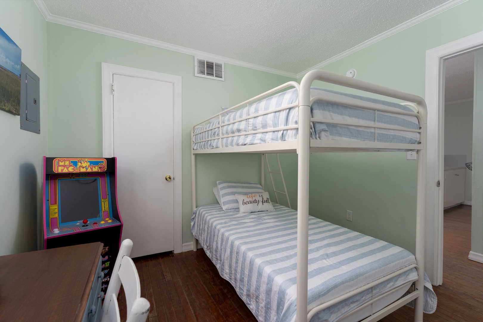 Your kids will love this fun bedroom with comfy bunk beds and their own arcade game for endless entertainment.
