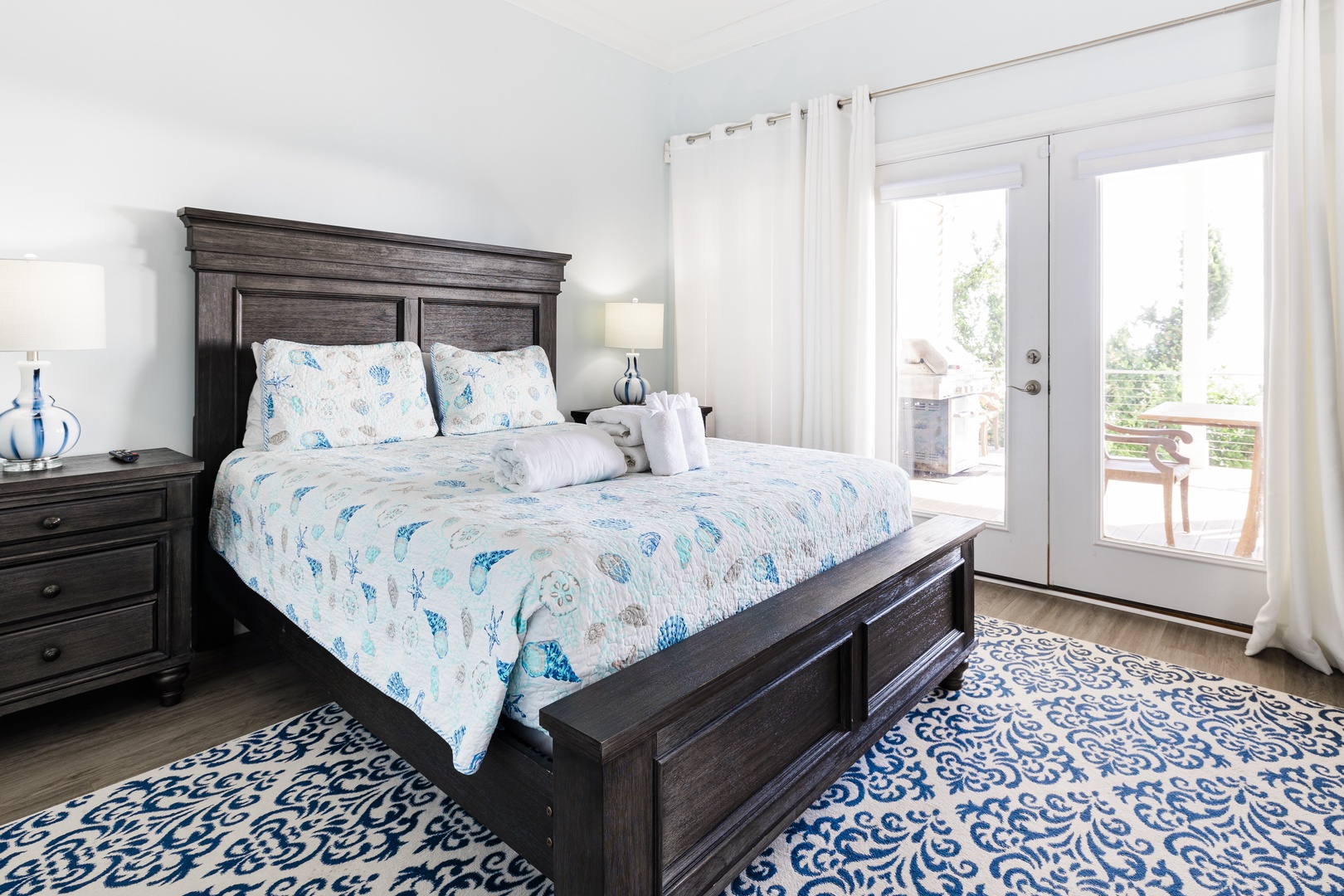 Sink into this dreamy bed with coastal blue linens and step out to your private balcony for morning coffee.