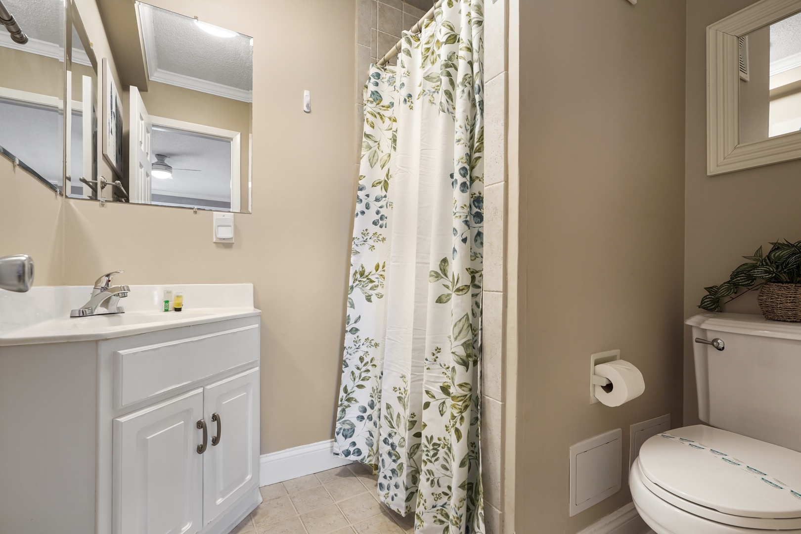Refresh in your private bathroom featuring a floral shower curtain and modern vanity—perfect for your morning routine.
