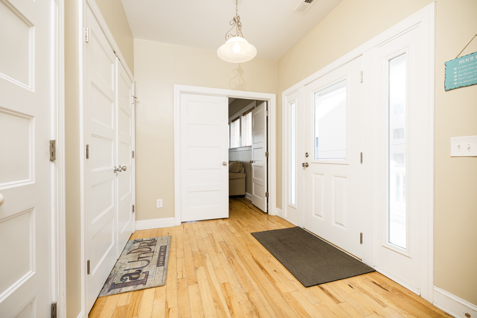 Step into your welcoming entryway with gleaming hardwood floors and charming pendant lighting that sets a warm, homey tone for your stay.