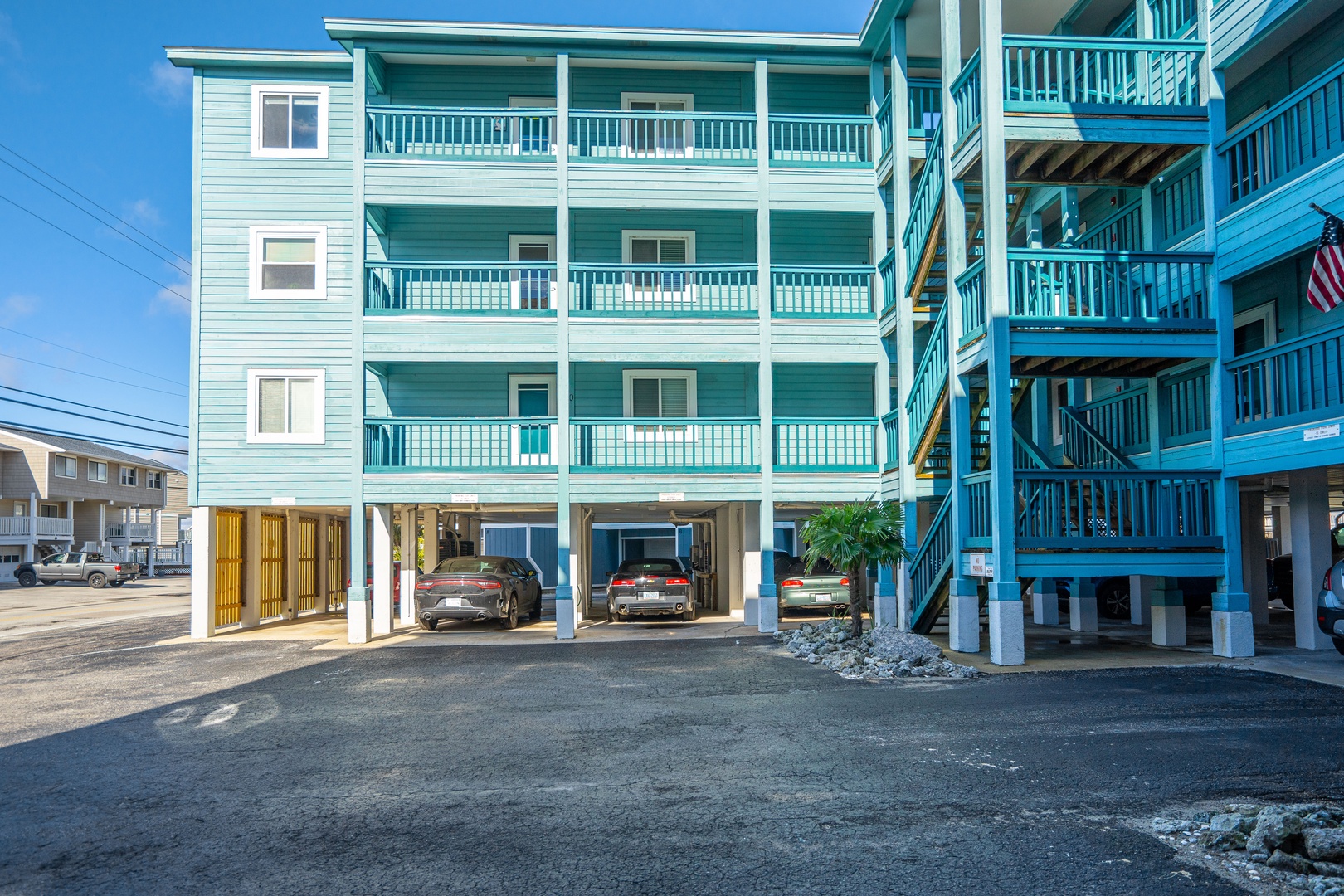 Coastal vacation property featuring multiple levels of private balconies and convenient ground-level parking for all guests.