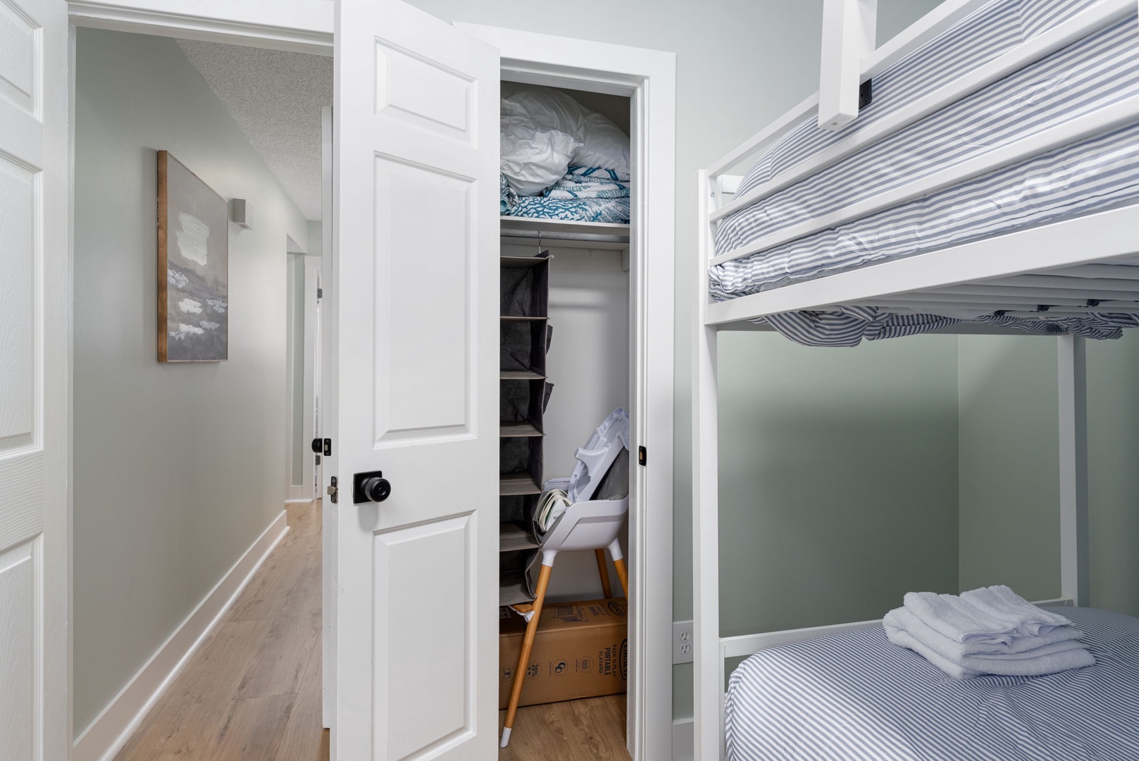 A tidy bedroom with bunk beds awaits you, complete with fresh linens and organized closet storage. Clean lines and soft lighting make this a restful retreat after your day of adventure.