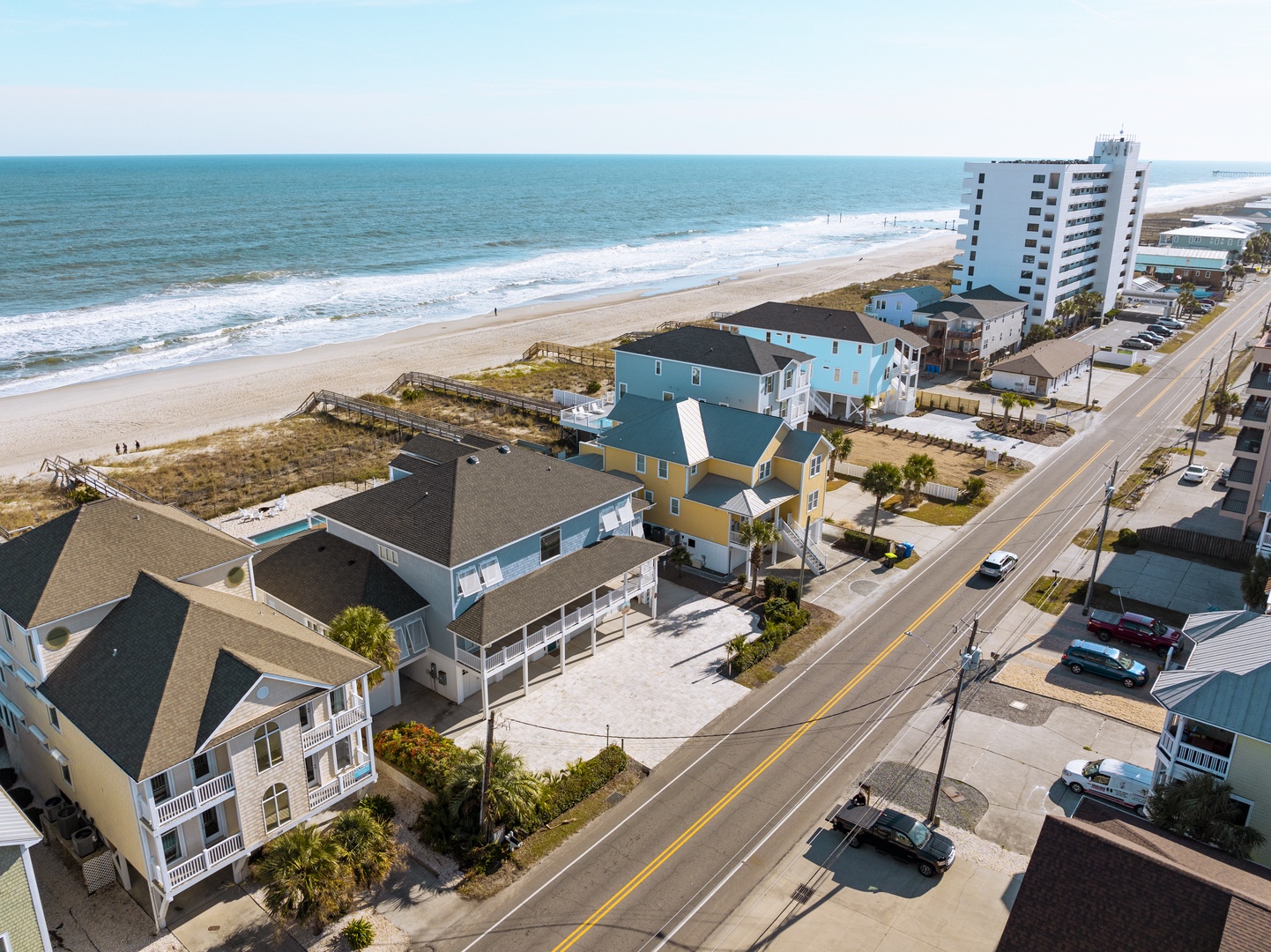 Beachfront vacation rentals line the pristine coastline, offering quick access to sandy beaches and ocean waves just steps from the front door.