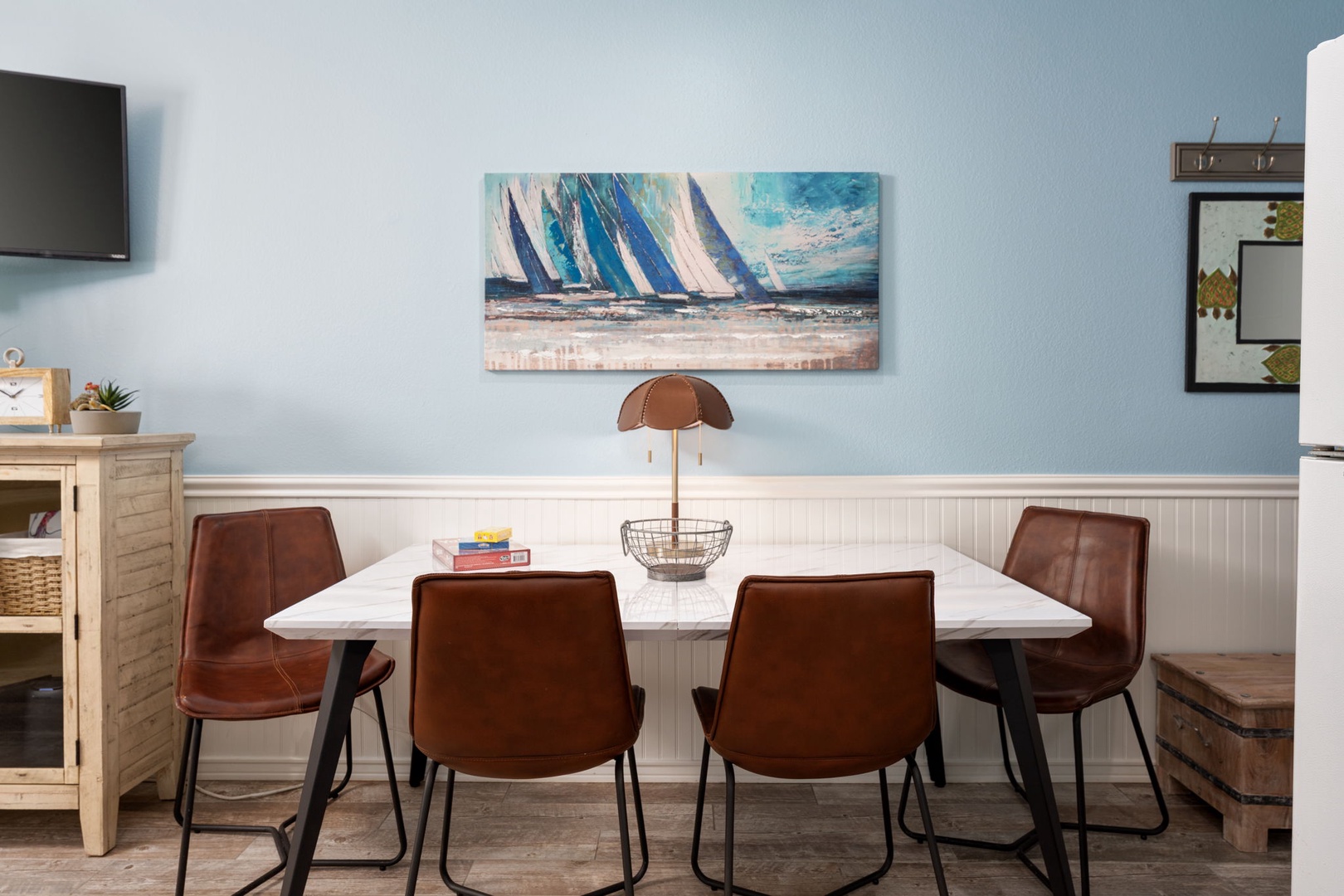 Gather around your elegant dining table for memorable meals, surrounded by coastal charm and modern comfort.