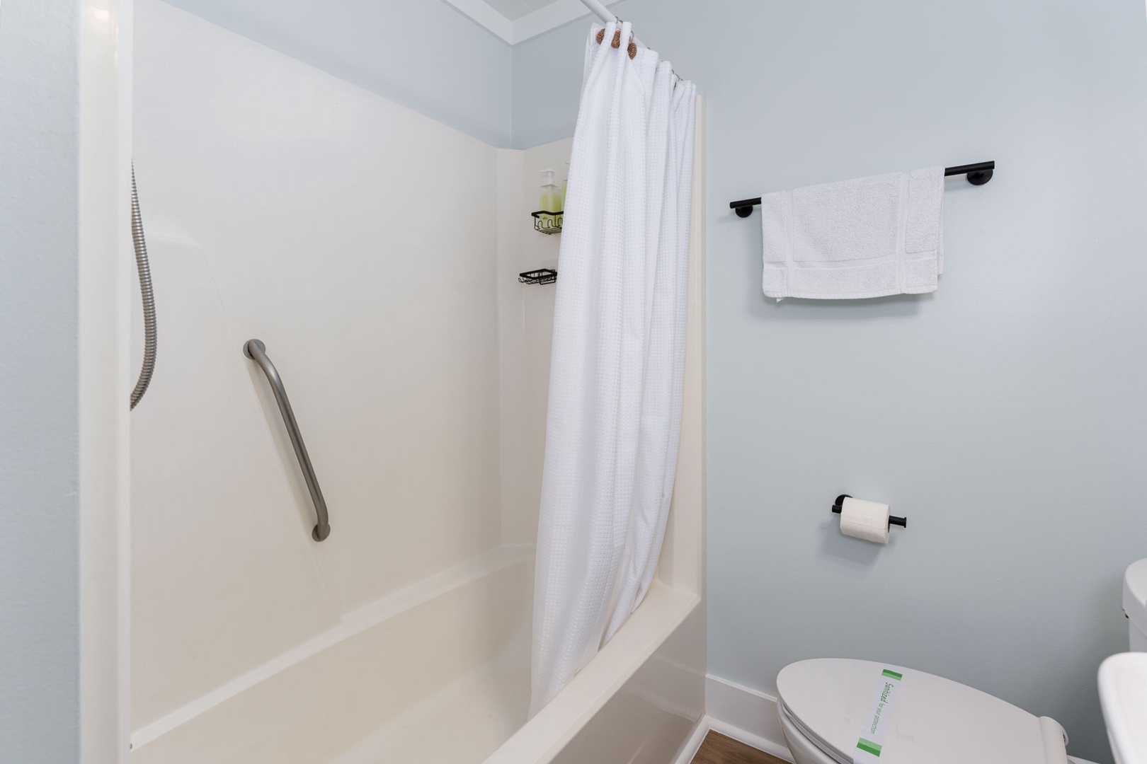 Refresh in this clean, accessible bathroom with a full tub-shower combo, safety grab bar, and plush towels ready for your arrival.
