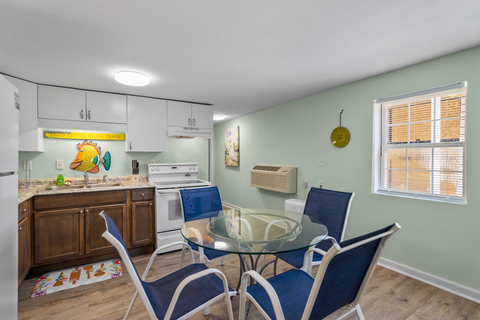 Your bright kitchen-dining area features granite counters, modern appliances, and a glass table perfect for morning coffee or evening meals together.