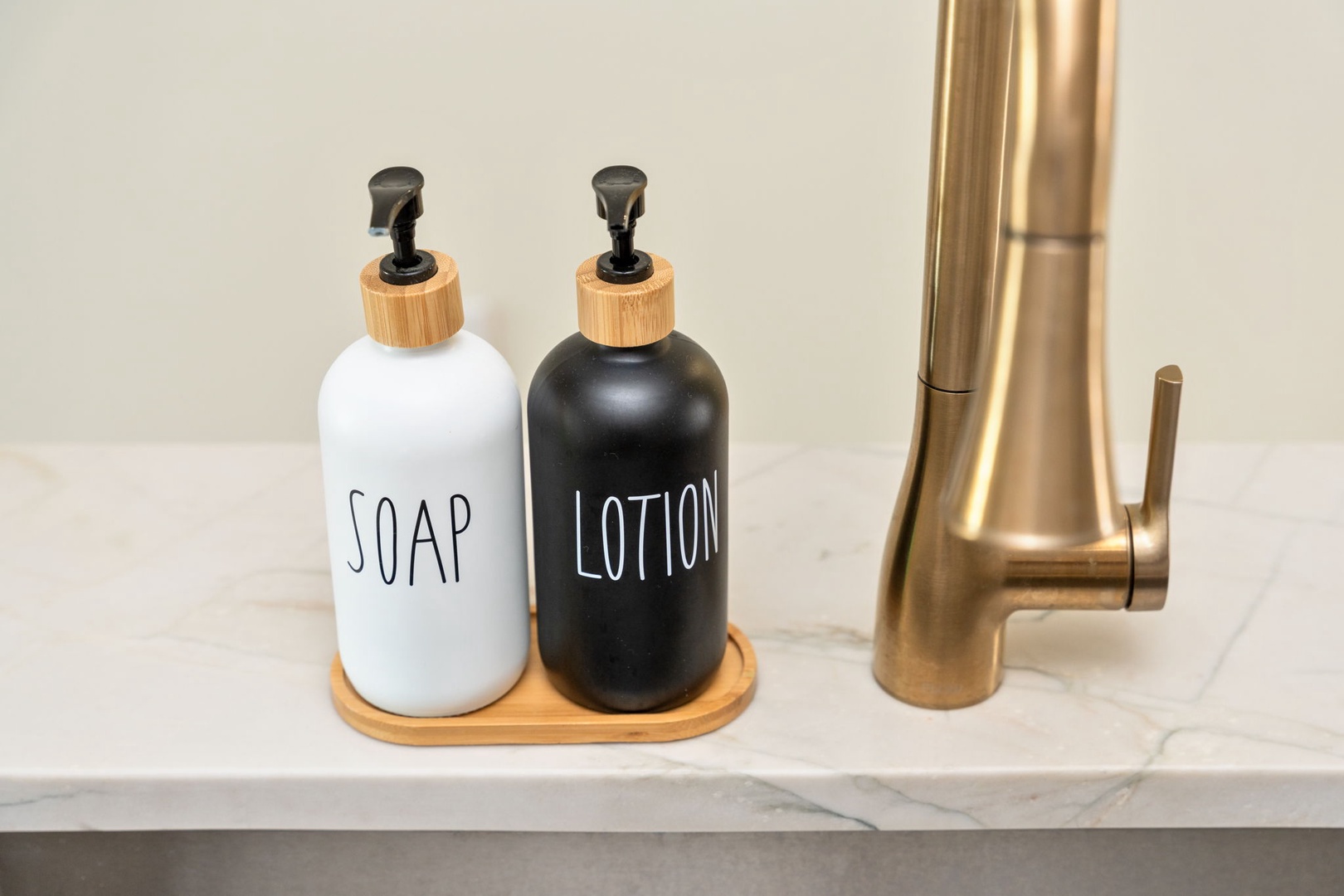 Stylish soap and lotion dispensers paired with brass fixtures create your perfect handwashing station with modern elegance.