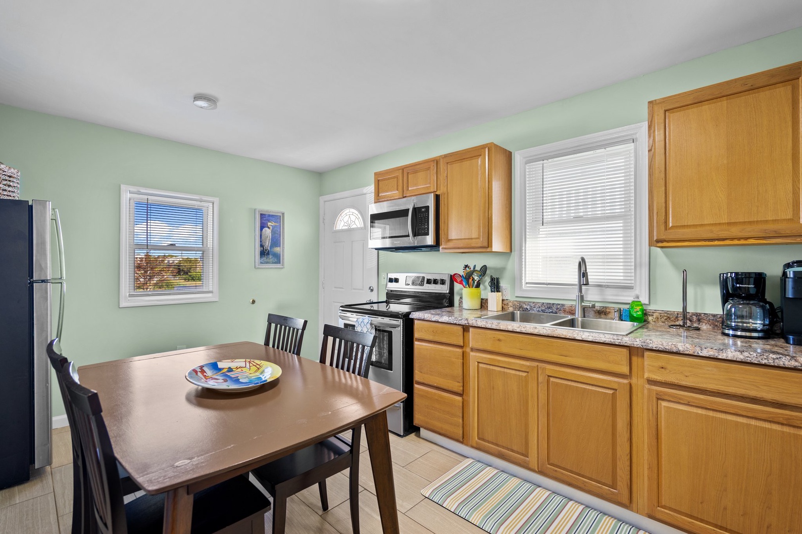 Cook your favorite meals in this bright, fully-equipped kitchen with modern appliances and granite countertops.