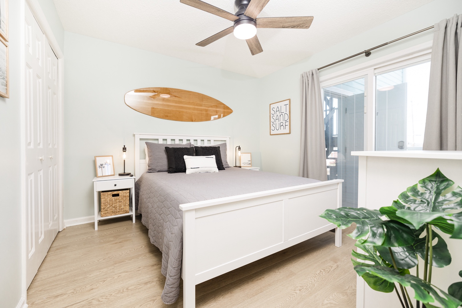 Drift off to peaceful sleep in your bright, coastal-inspired bedroom with comfortable queen bed and gentle ceiling fan breeze.