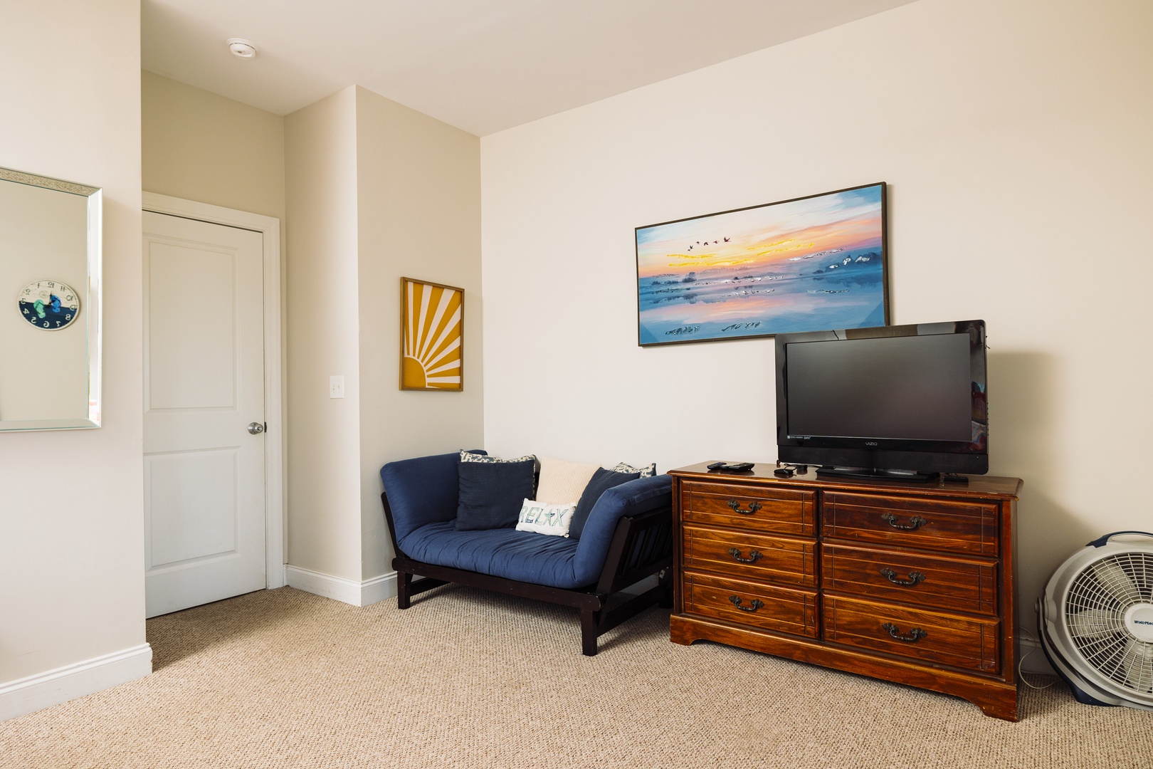 Unwind in your cozy sitting area with comfortable seating and entertainment setup for relaxing evenings.