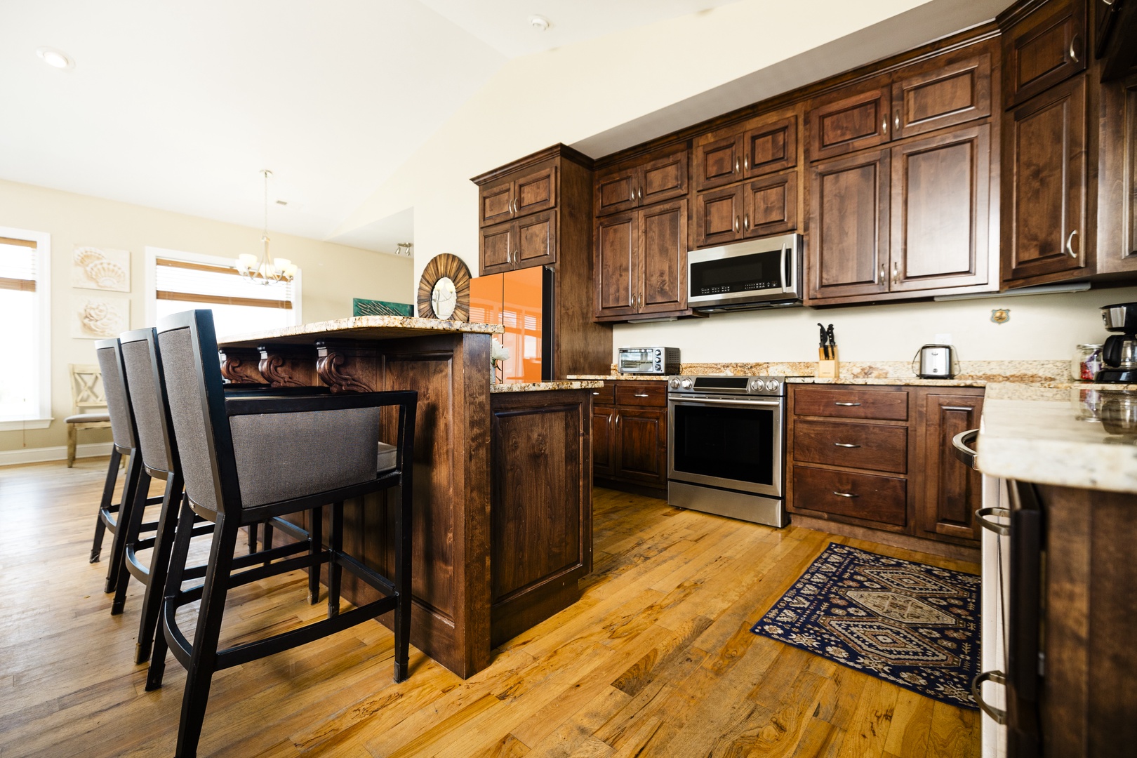 Your spacious kitchen boasts rich wood cabinetry, granite counters, and modern appliances perfect for preparing memorable meals together.