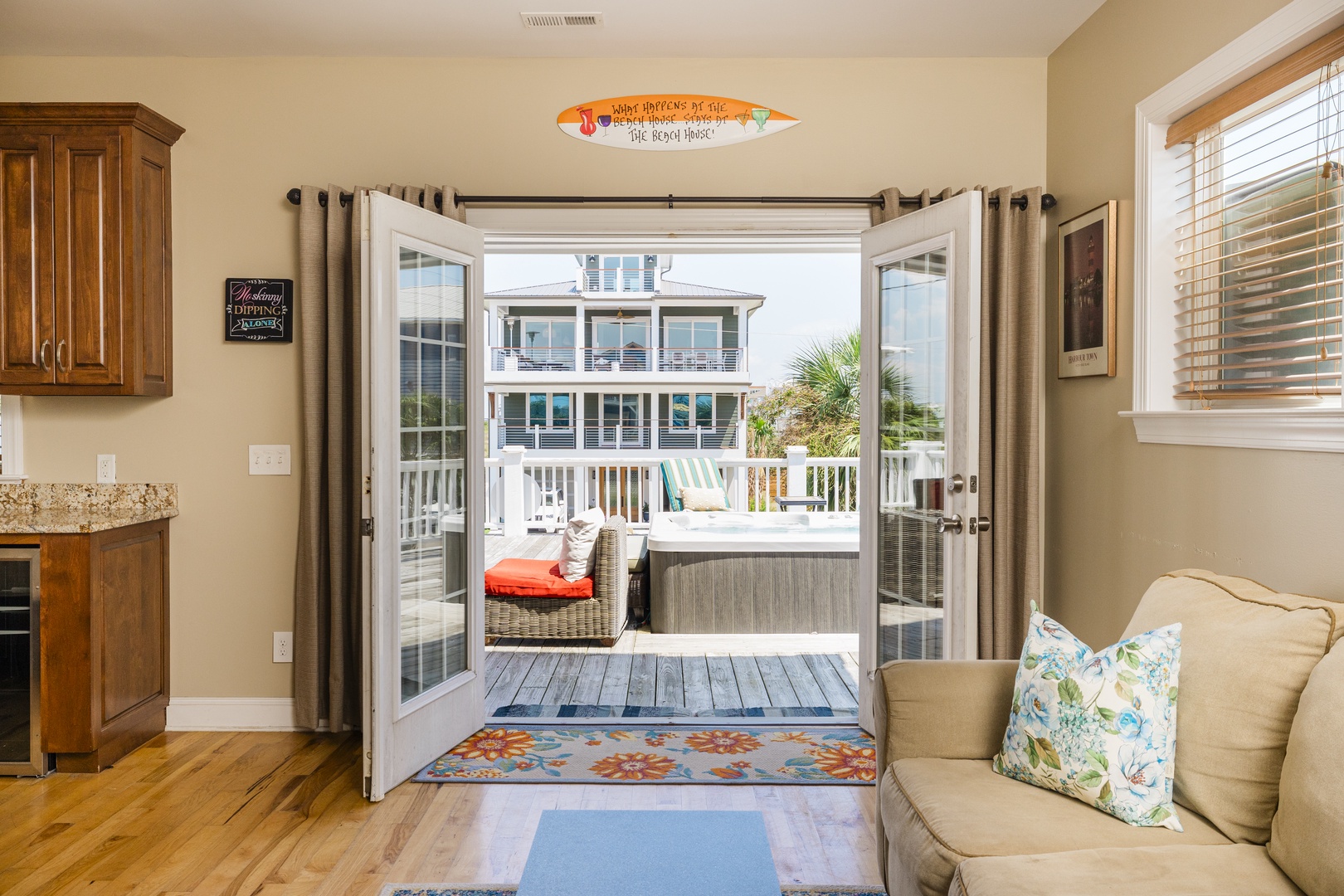 Step from your cozy living room through French doors onto your private deck with hot tub and beach house views.