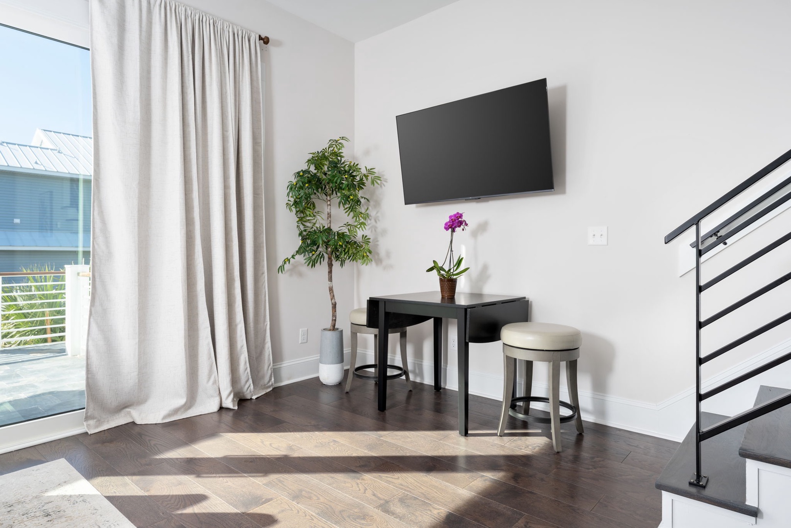 Unwind in your modern living space with a flat-screen TV and charming breakfast nook perfect for morning coffee.