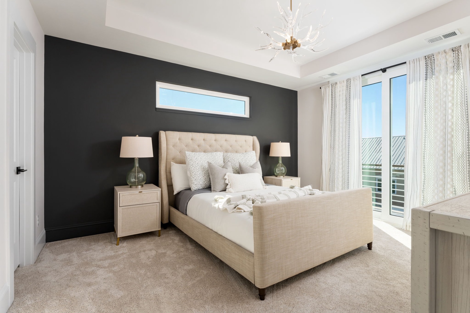 Sink into your luxurious upholstered bed with soft linens, surrounded by elegant neutrals and natural light from your private balcony.