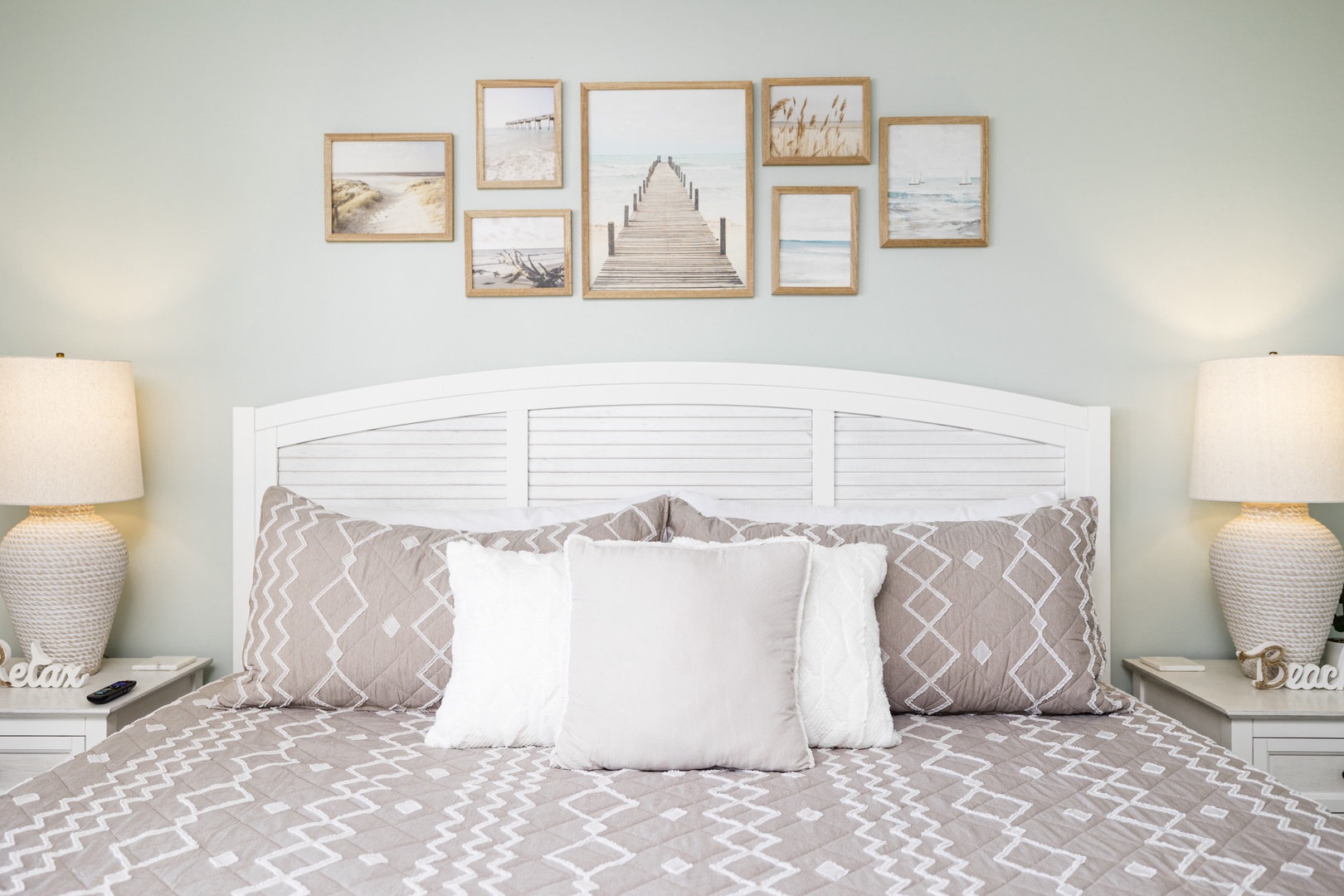 Drift off peacefully in your coastal-themed bedroom with soft linens and serene beach artwork creating the perfect seaside escape.