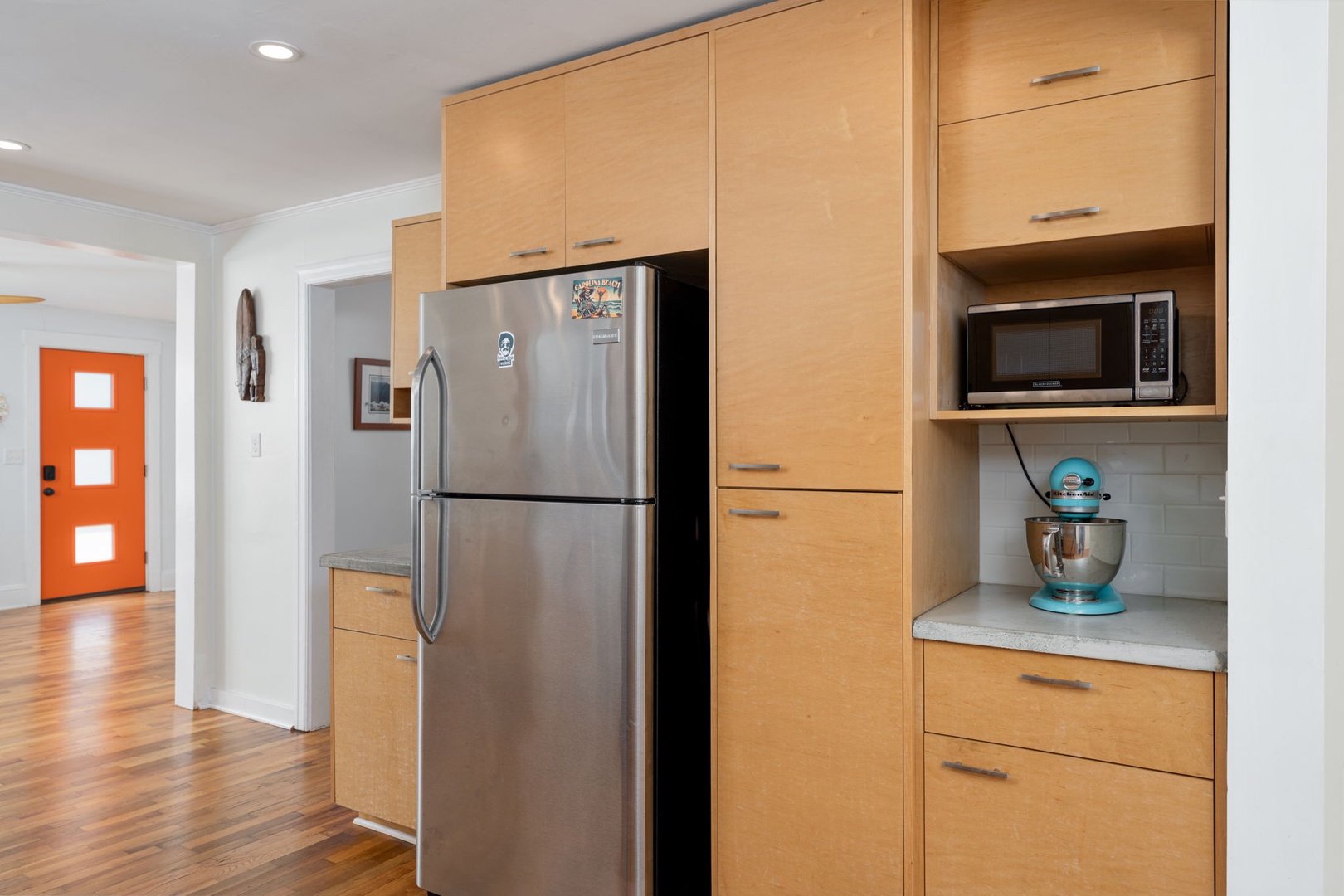 Your fully-equipped kitchen features sleek maple cabinetry, stainless steel appliances, and thoughtful storage solutions for effortless home cooking.