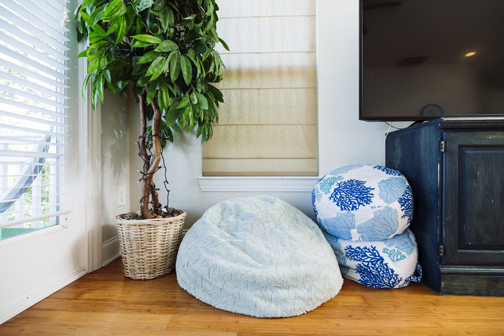 Unwind in your cozy corner with a plush bean bag and ocean-themed pillows, perfect for relaxing while enjoying natural light.