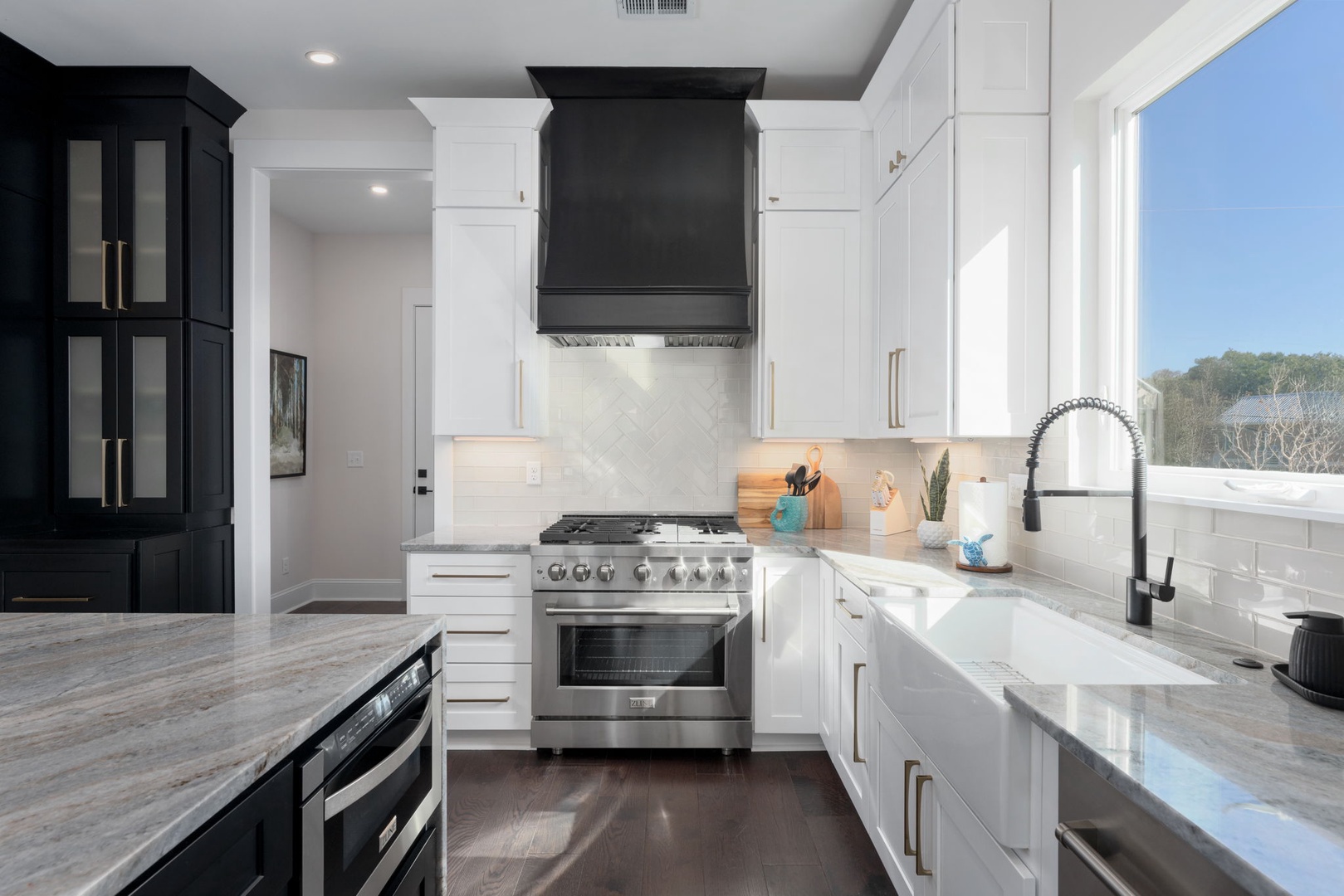 Your dream kitchen awaits with gleaming marble countertops, professional appliances, and abundant natural light streaming through picture windows.