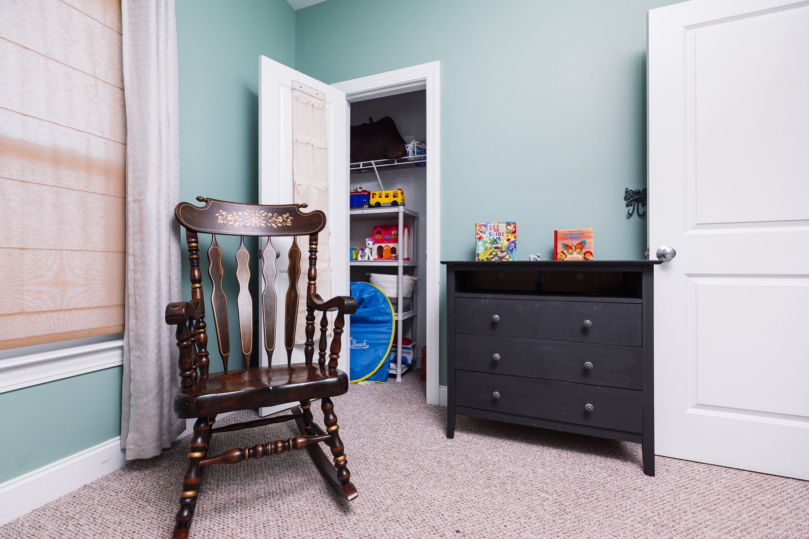 Your little ones will love this cozy bedroom with a charming rocking chair and plenty of storage for toys and clothes.