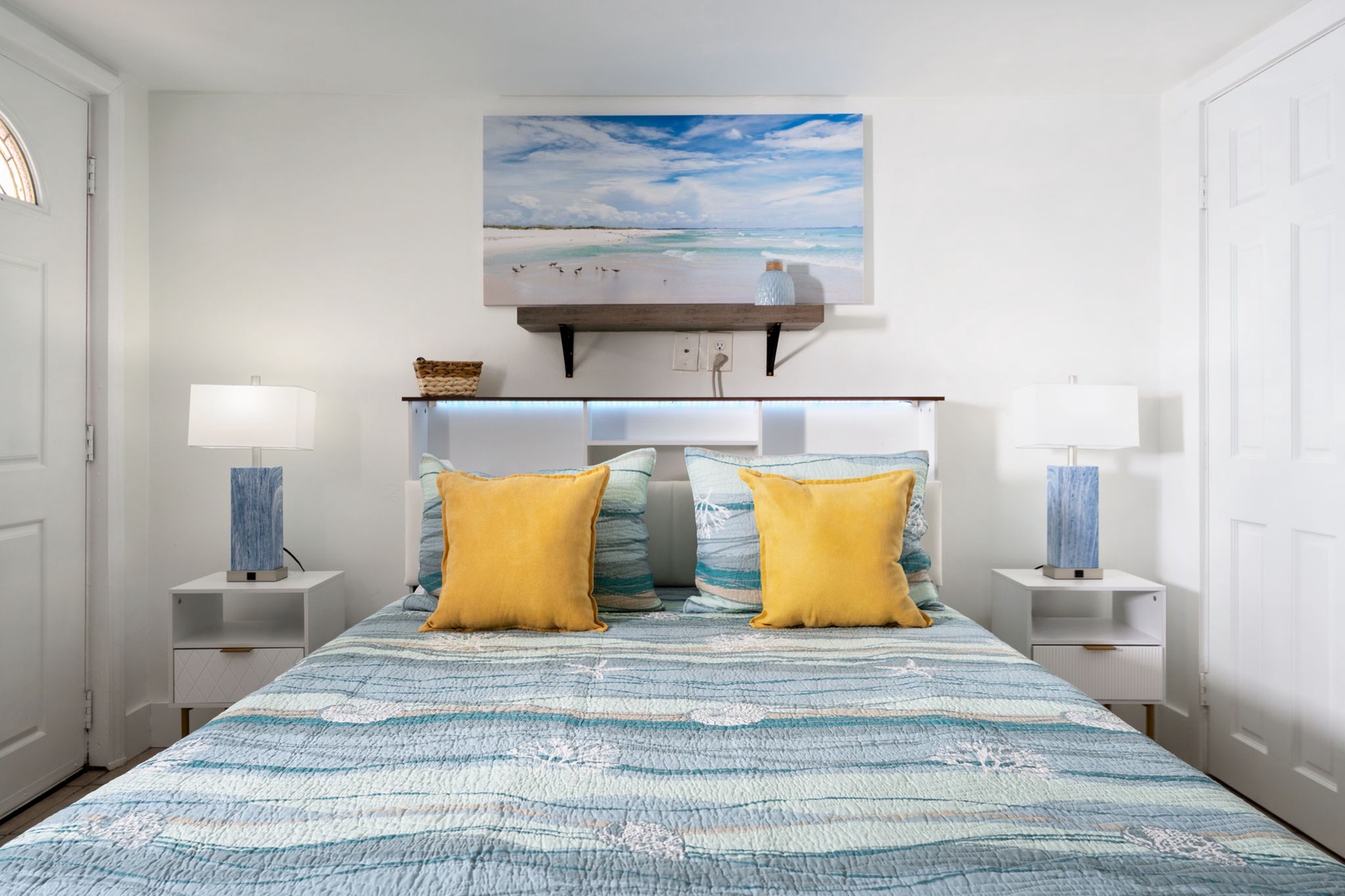 Drift off to sleep surrounded by coastal serenity in your bright, cheerful bedroom with ocean-inspired décor and soft lighting.