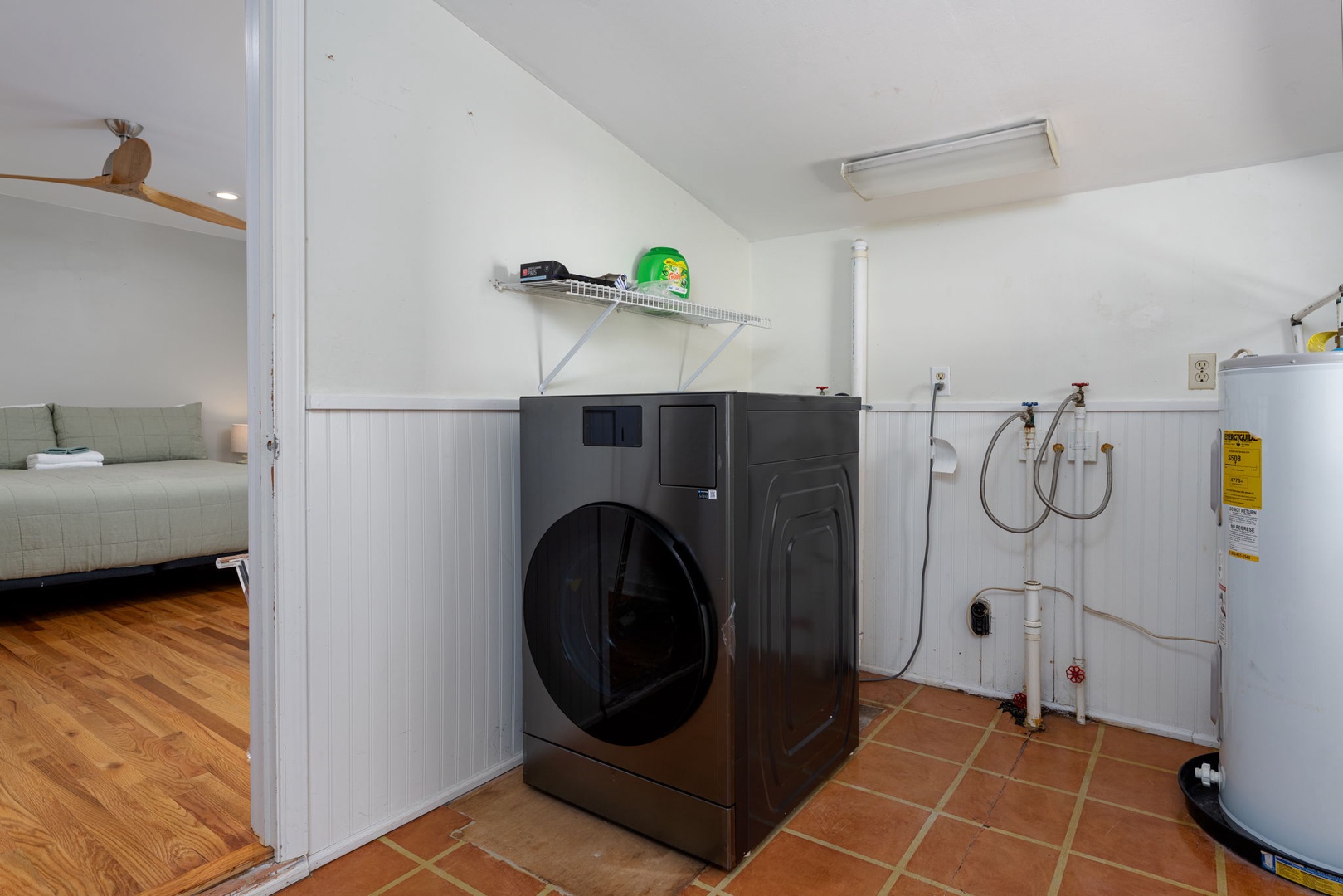 Your private laundry room keeps your clothes fresh during extended stays, with modern washer and convenient storage shelving.